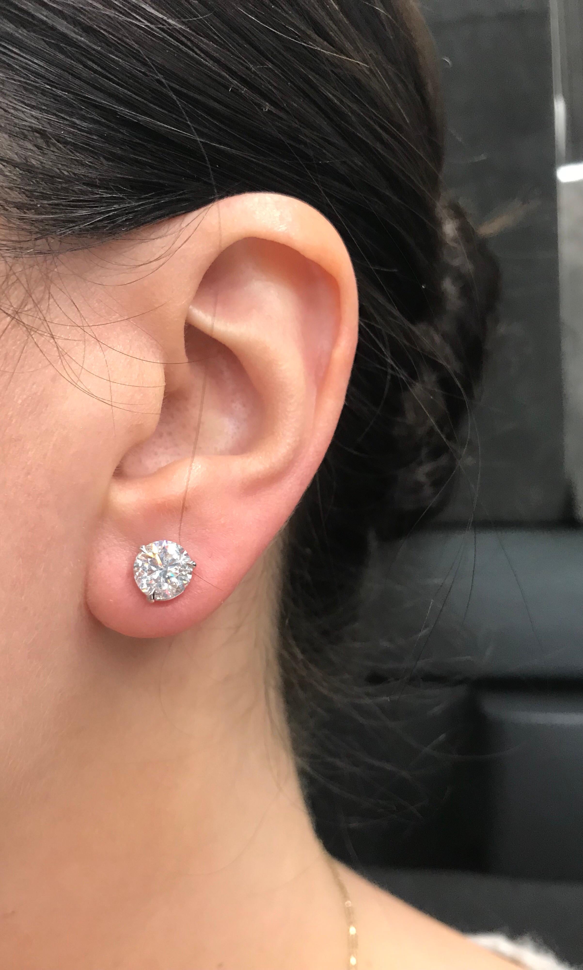 Diamond stud earrings weighing 3.14 carats in a three prong champagne setting, in 18k white gold. 
Color: G-H
Clarity: I1
Our champagne setting is sold exclusively at Harbor Diamonds and sits closer to the ear than a martini setting. 