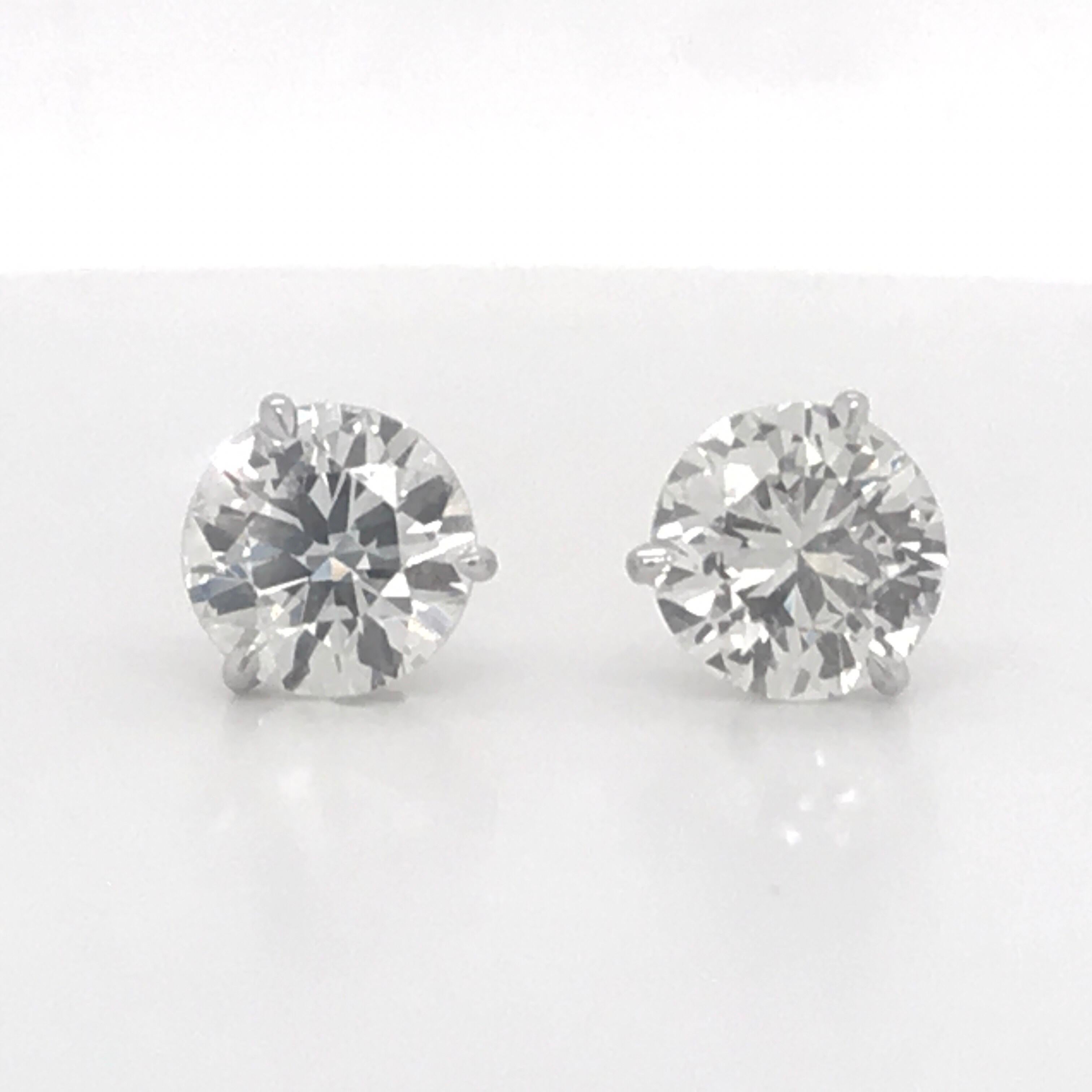 Diamond stud earrings weighing 3.78 Carats in a 18K white gold 3 prong champagne setting.  
Color J 
Clarity SI1-SI2