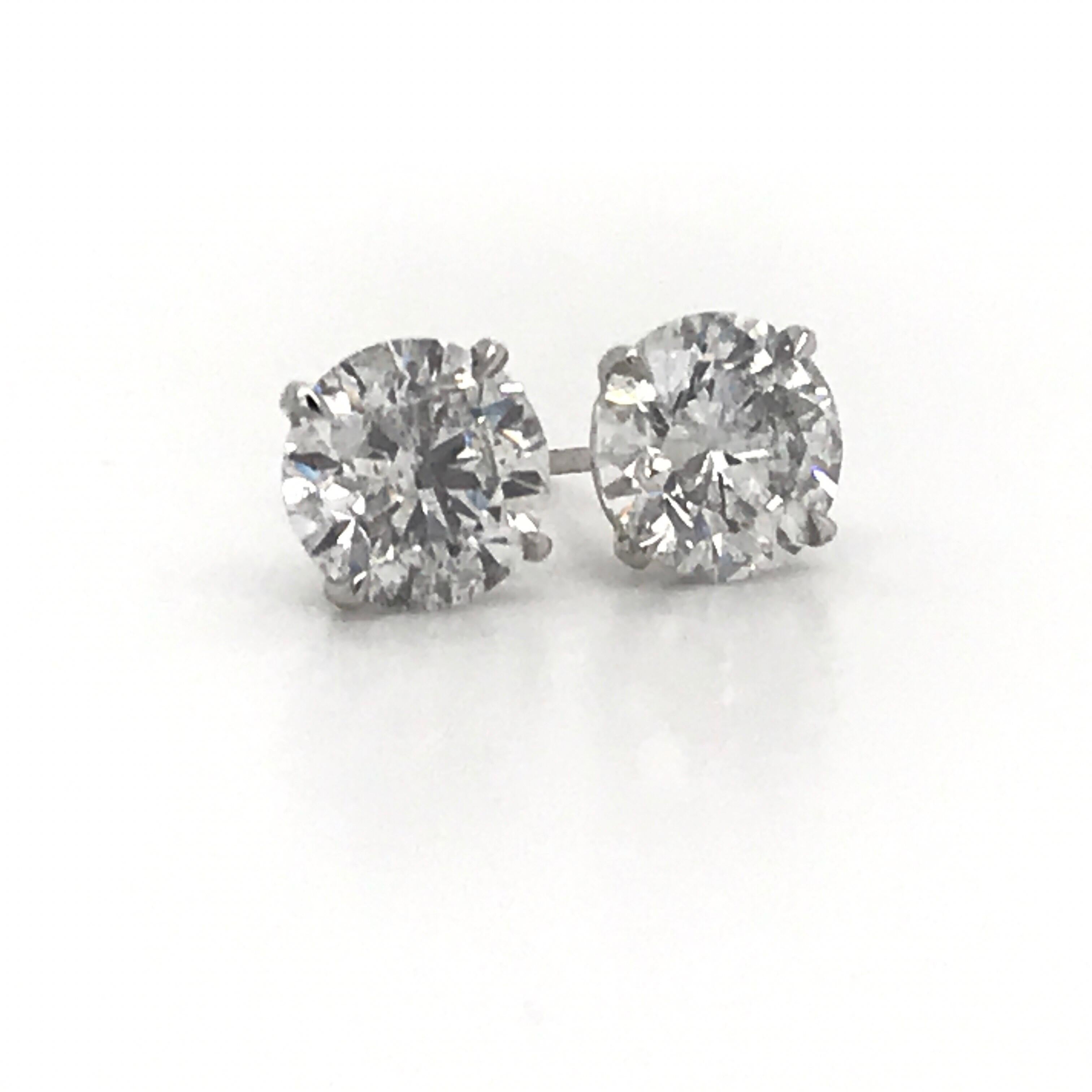 Diamond stud earrings weighing 4.07 Carats in 18K white gold 4 prong champagne studs.
Color I 
Clarity I1 
