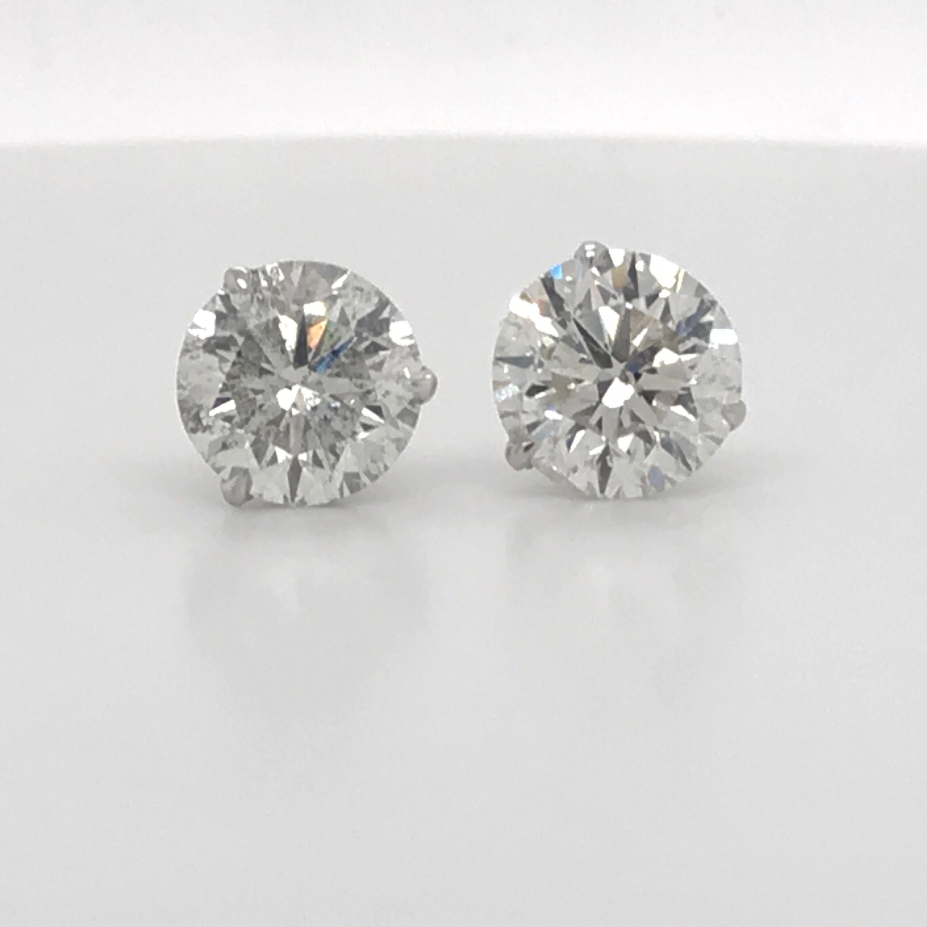 Diamond stud earrings weighing 4.87 Carats in a 14K white gold 3 prong martini setting. 
Color I-J 
Clarity I1