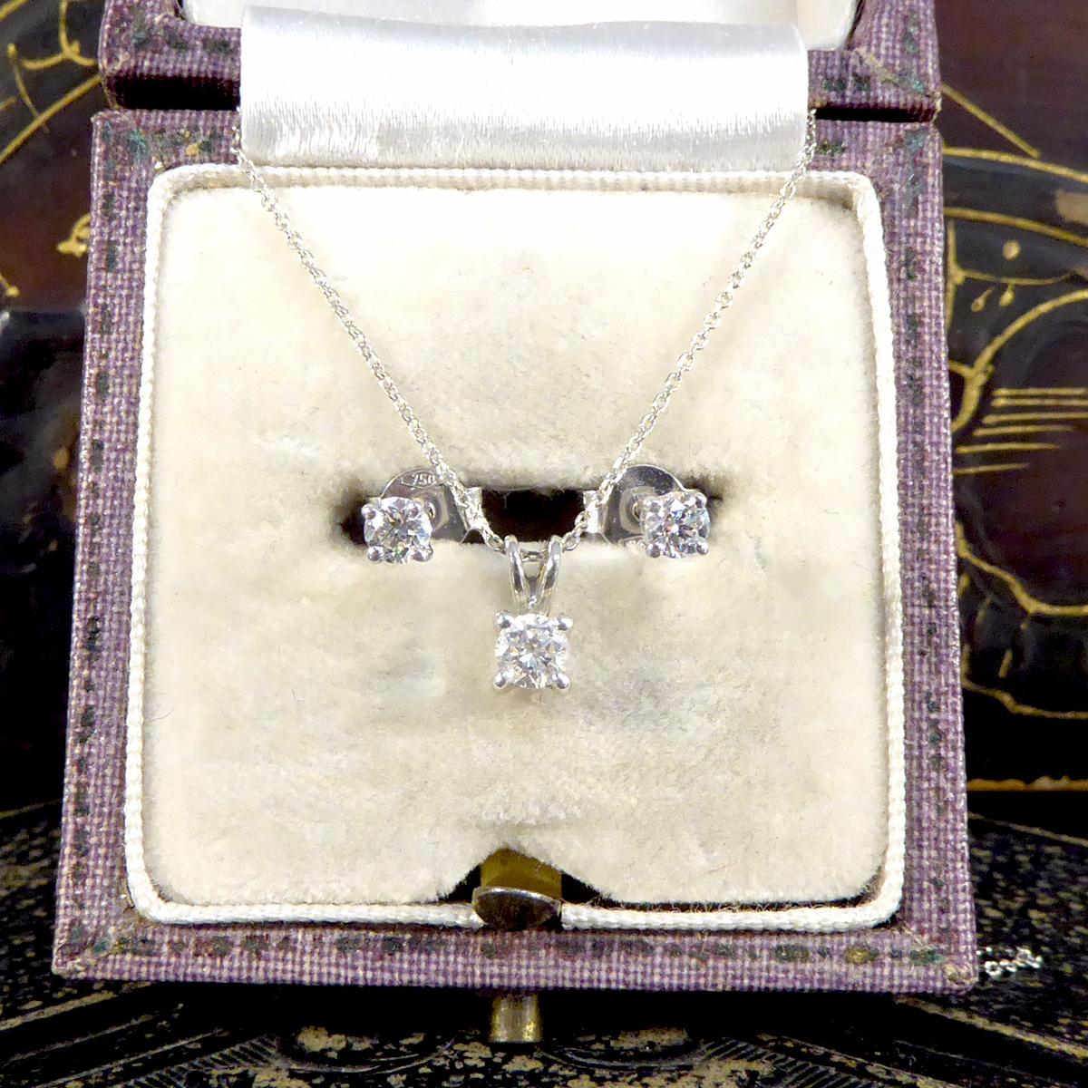 A classic pair of Diamond stud earrings and pendant necklace set, the perfect gift for any loved one. Featuring are a pair of Diamond stud earrings totalling 0.25ct set in an 18ct White Gold four claw box setting. Alongside these stud earrings are