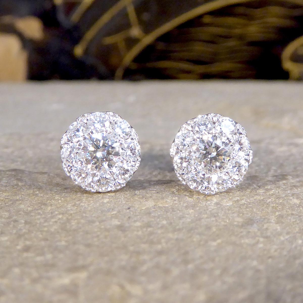 A beautifully sparkly pair of Dimond Earrings. At the heart of each stud features a carefully arranged cluster of diamonds with a total weight of 1.00ct, meticulously set to mimic the brilliance and size of a much larger, solitary diamond giving