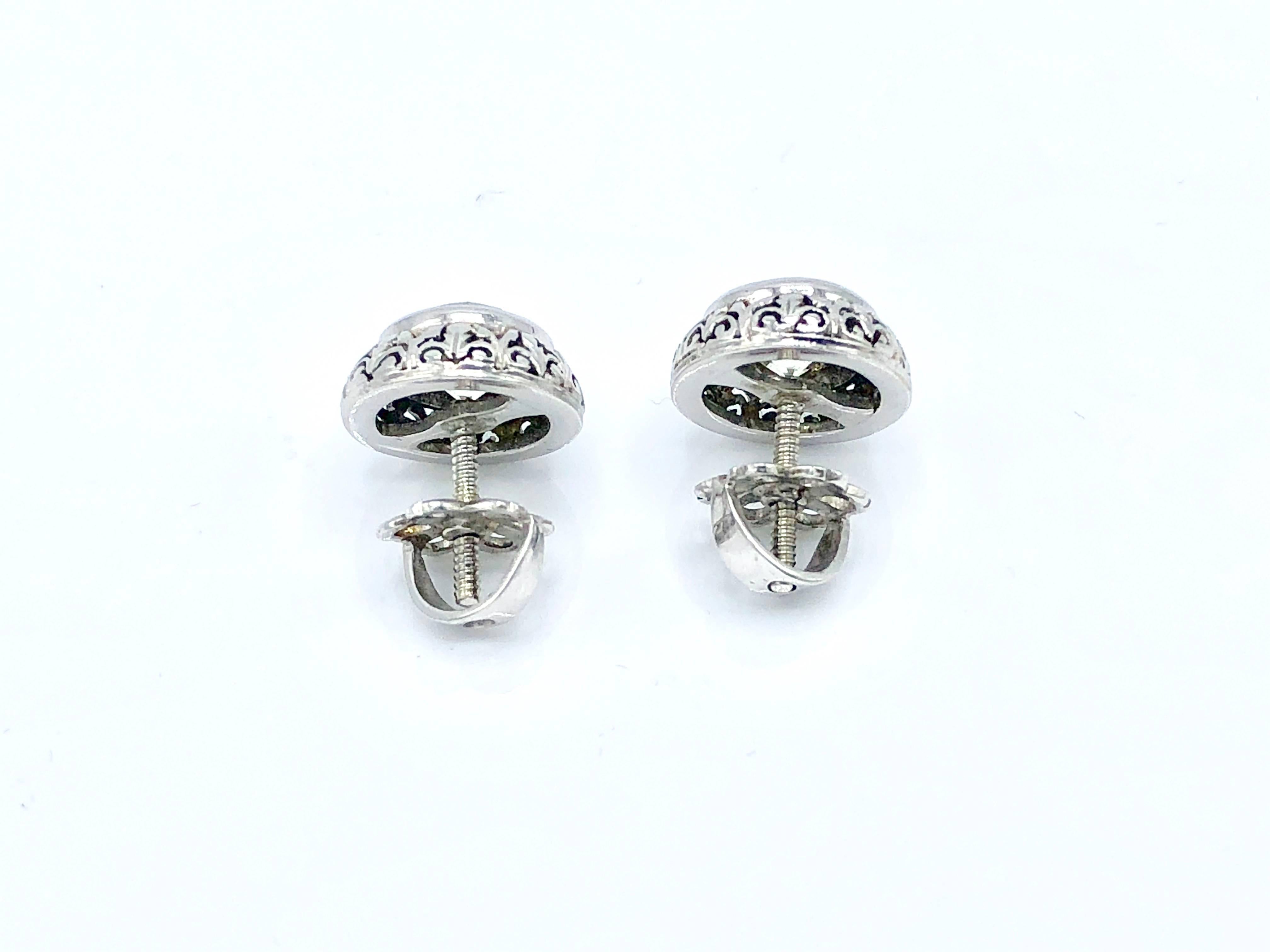An elegant pair of platinum and diamond stud earrings. The total carat weight is 2 ct circa