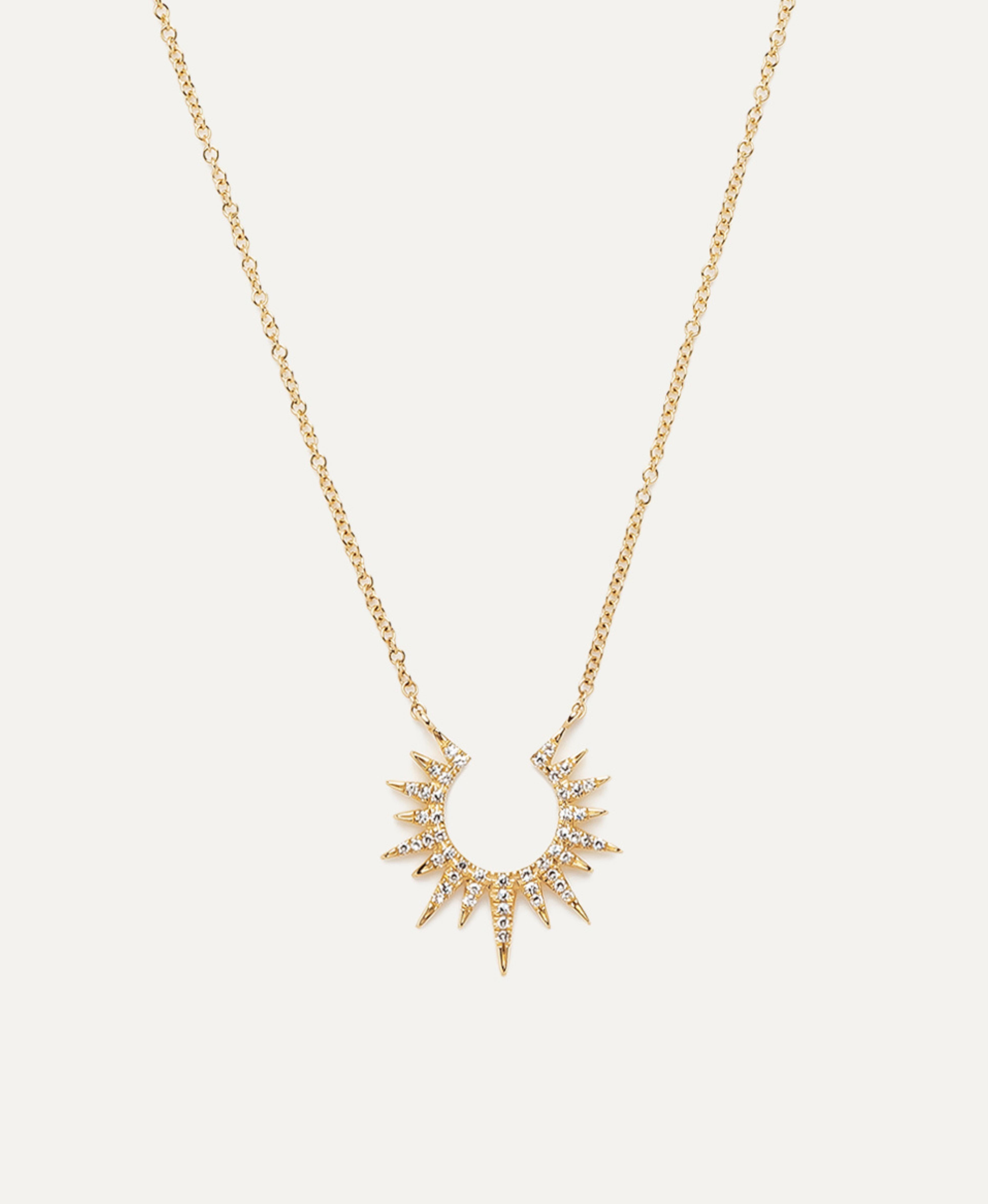 The Diamond Sunburst Necklace is a radiant and captivating jewelry piece inspired by the brilliance of the sun. Crafted from luminous 14k yellow gold, this pendant necklace features a sunburst design, where a dazzling array of white diamonds is