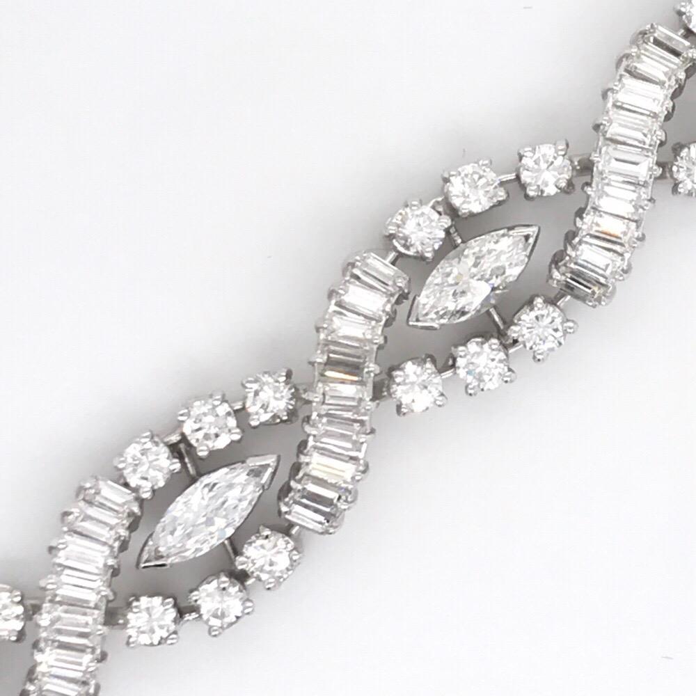 Platinum bracelet featuring 9 marquise cut diamonds and alternating baguette and round brilliants weighing a total of 10 carats. 
Color G-H
Clarity SI
