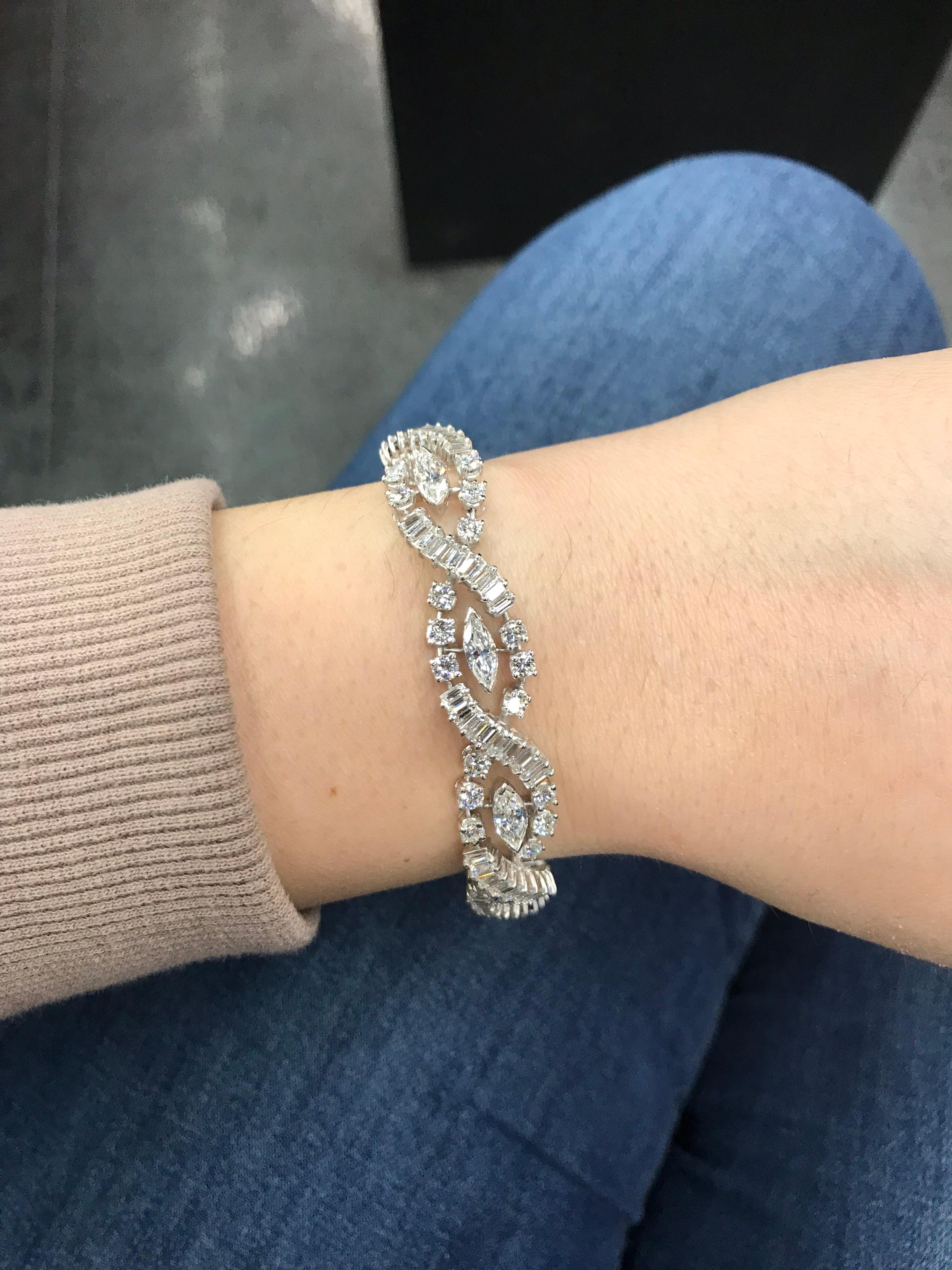 Platinum bracelet featuring 9 marquise cut diamonds and alternating baguette and round brilliants weighing a total of 10 carats. 
Color G-H
Clarity SI