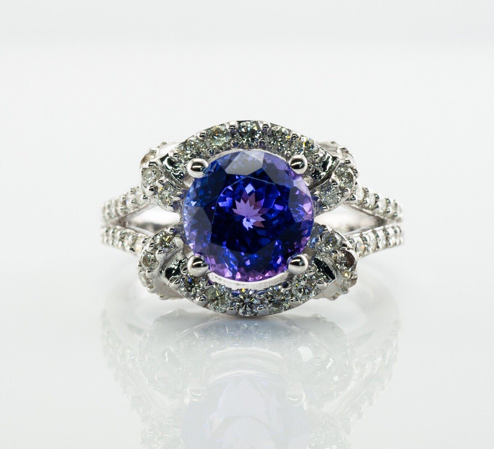 This gorgeous estate ring is finely crafted in solid 18K White gold and set with genuine Earth mined Tanzanite and Diamonds. It is also hallmarked 