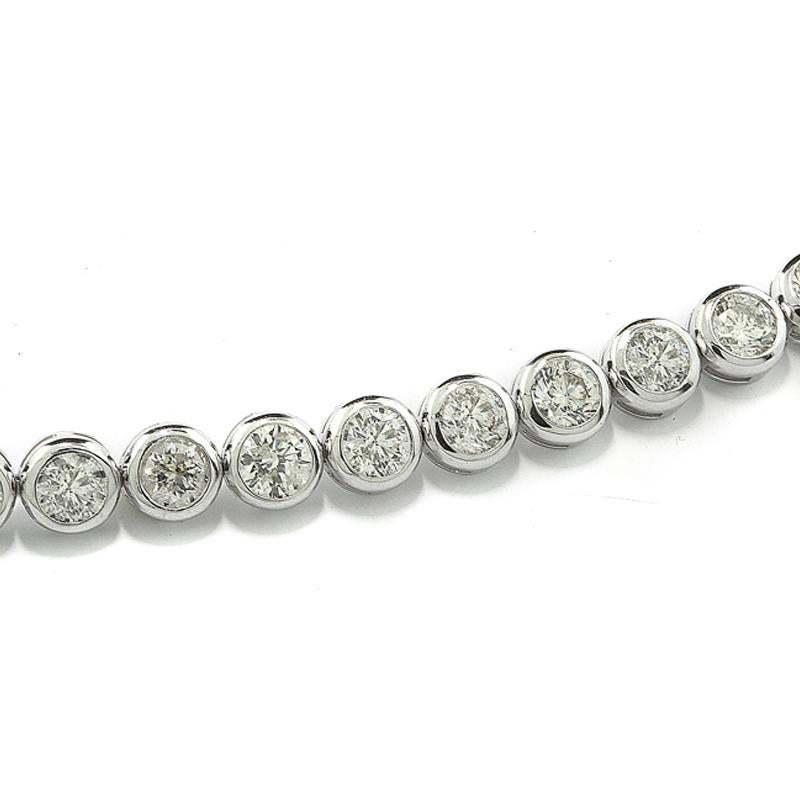 A luxurious bracelet adorned with 28 natural white diamonds in brilliant cut, approx. 10.81 carats in total, color: H-I,  clarity:  SI 1-3. The diamonds are securely cradled in broad round bezels, creating a bespoke appearance that gracefully