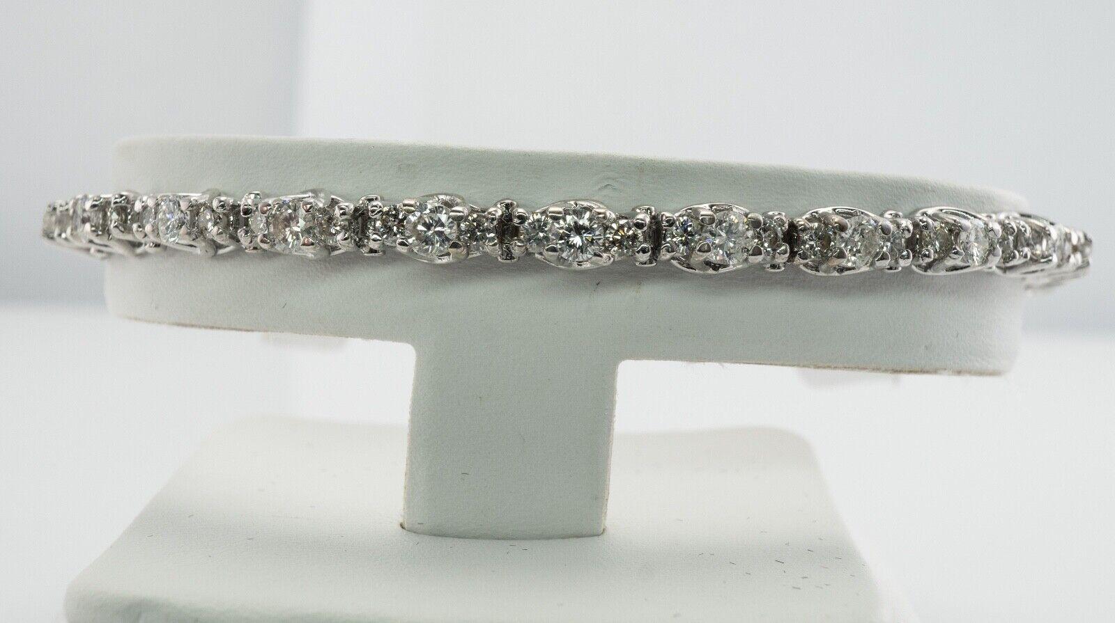 Natural Diamond Tennis Bracelet 14K White Gold 3.38 TDW

This amazing estate diamond tennis bracelet is crafted in solid 14K White gold (stamped) and set with white and fiery round brilliant cut diamonds. There are 25 diamonds totaling 2.50 carats,