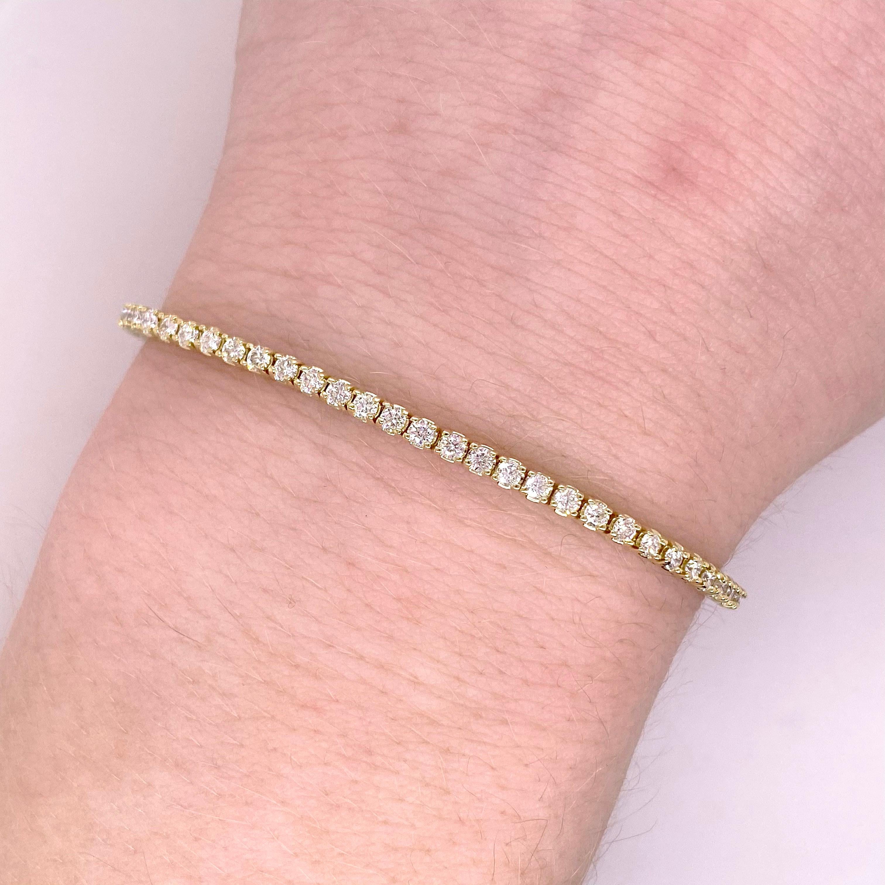 This 14 karat gold tennis bracelet has a total of 2 carats of diamonds! These are genuine diamonds and come with a certificate of authenticity and appraisal. The bracelet is 7 inches long but can be altered to a different length if ever needed..