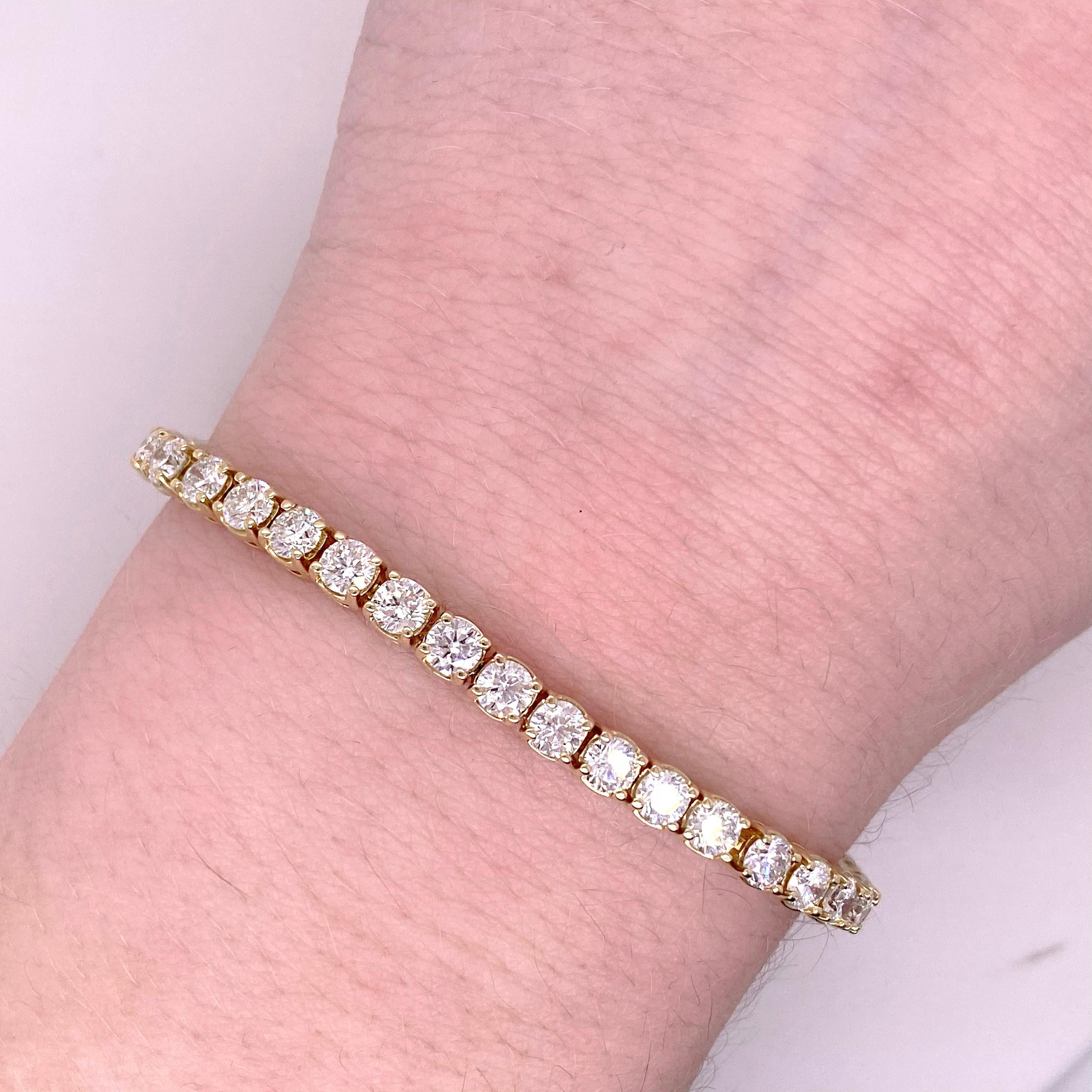 This diamond tennis bracelet has 7 carats of total diamond weight!  This four prong tennis bracelet is the perfect size so that you can see the diamonds and the gold is nice and sturdy and fine if you want to wear the bracelet everyday!  The yellow