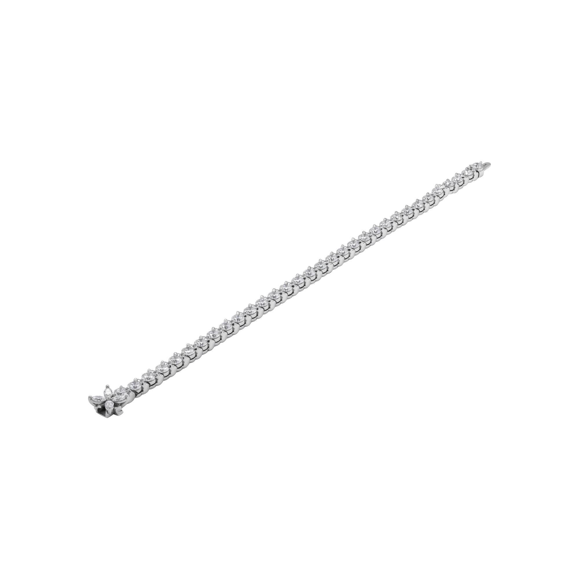 Diamond Tennis Bracelet
Timeless and classic!
Mounted in Platinum with 32 full brilliant cut round diamonds totaling 7.70ct (0.25 ct each stone) F-G color VVS clarity and 3 marquise shape diamonds on the clasp - an elegant touch - totaling 0.43ct