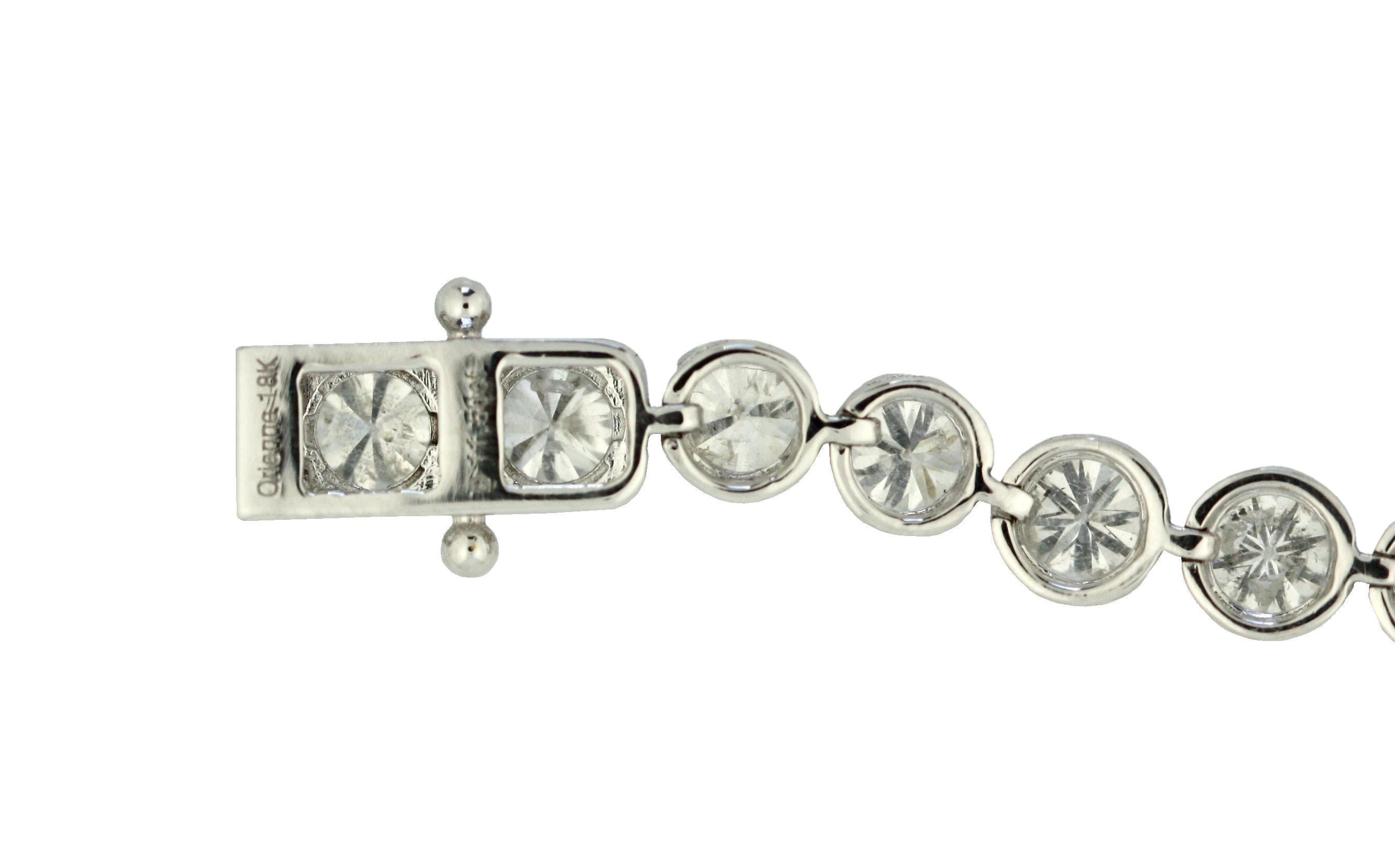 DIAMOND BRACELET 
The tennis bracelet composed of brilliant-cut diamonds together weighing approximately 11.50 carats, mounted in 18 karat white gold, length approximately 7 inches