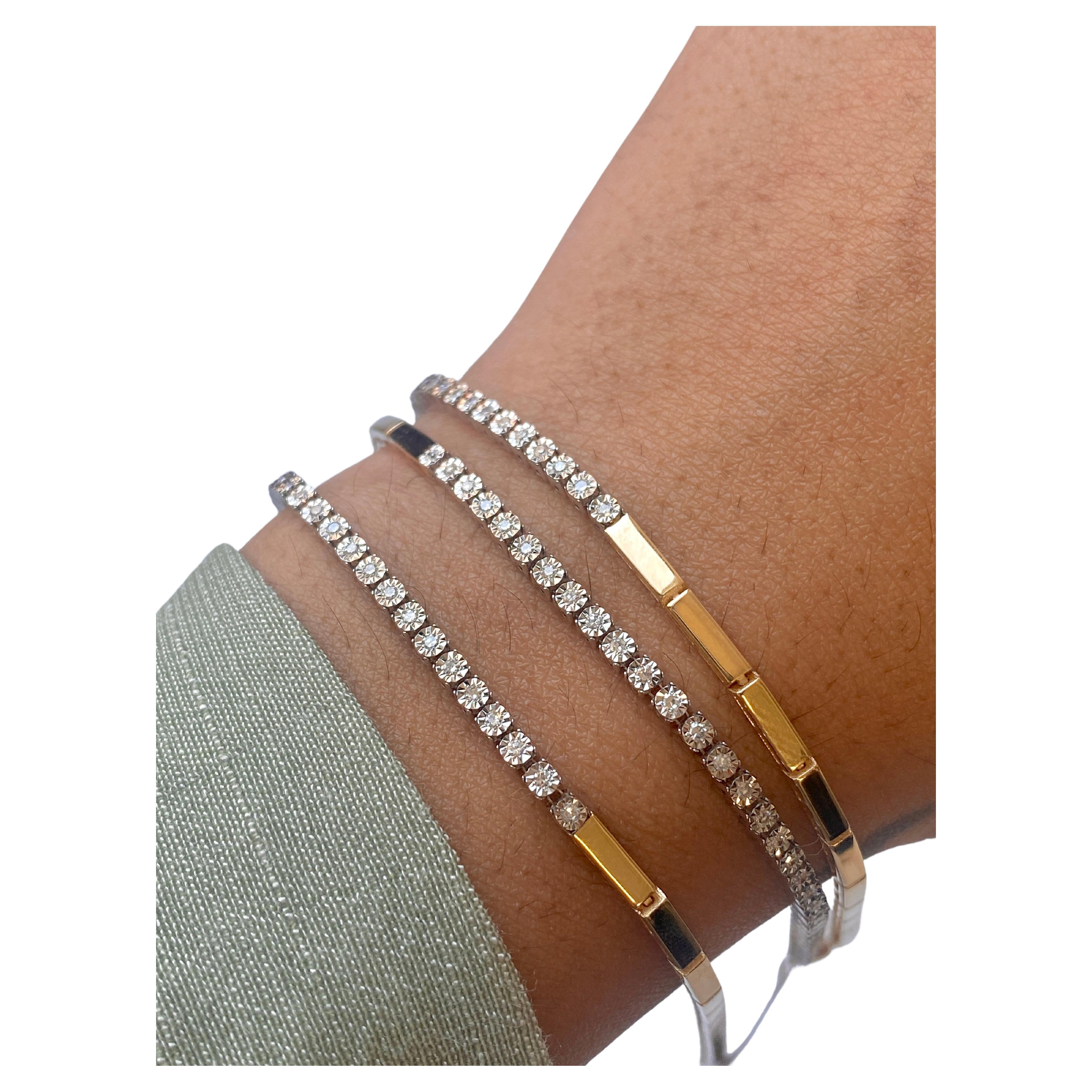 Half and half diamond bracelet

A dainty diamond tennis bracelet that is half white gold and half yellow gold! The unique part in this bracelet is that the diamonds are set in a miracle disc, so they look bigger to anyone that is looking at them!