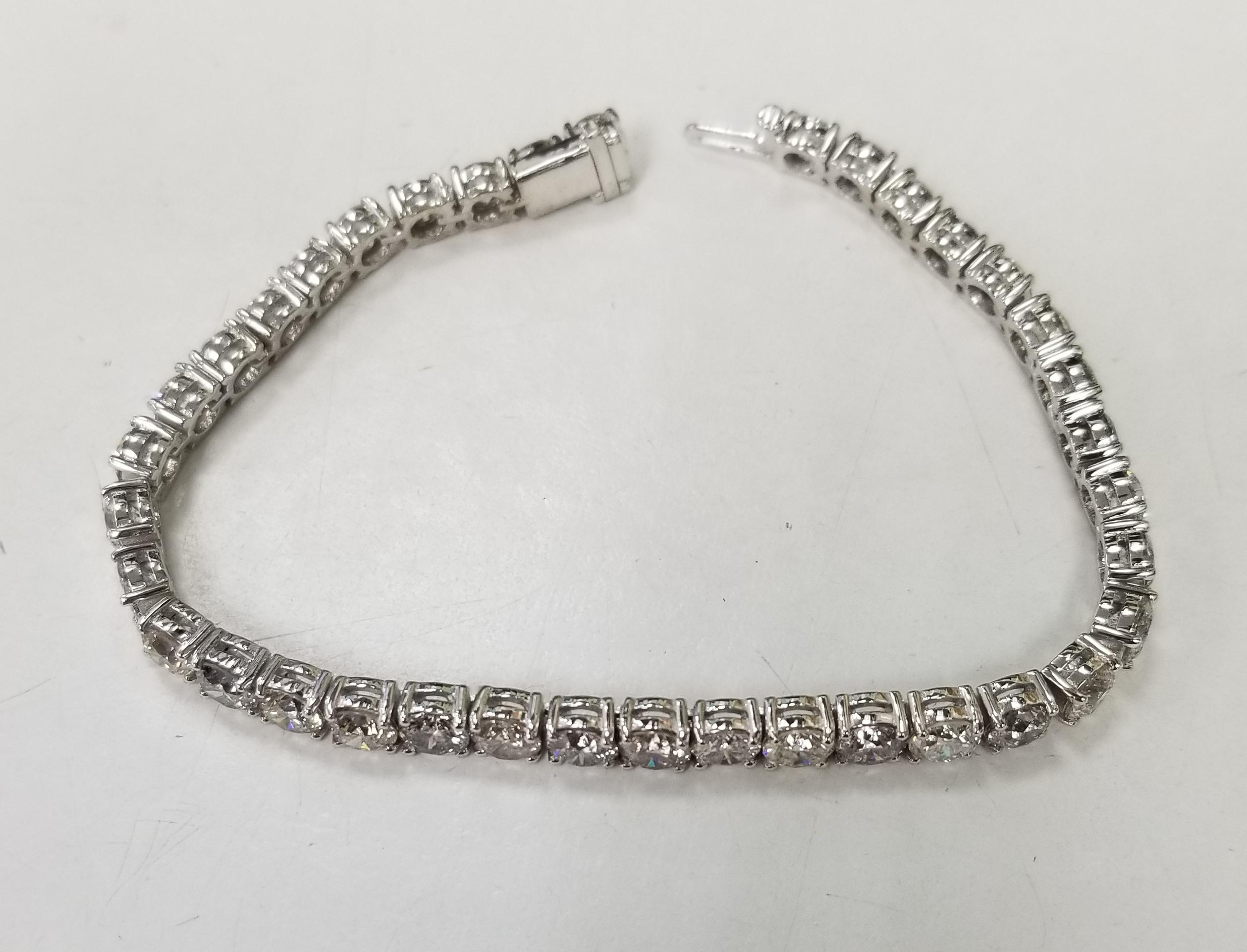 This is very beautiful 14k white gold custom made tennis bracelet with 37 round diamonds color H-I and clarity SI1-2 weighing 15.03cts. very fine quality diamonds, bracelet measures 7 inches with clasp and safety.
Specifications:
    main stone: