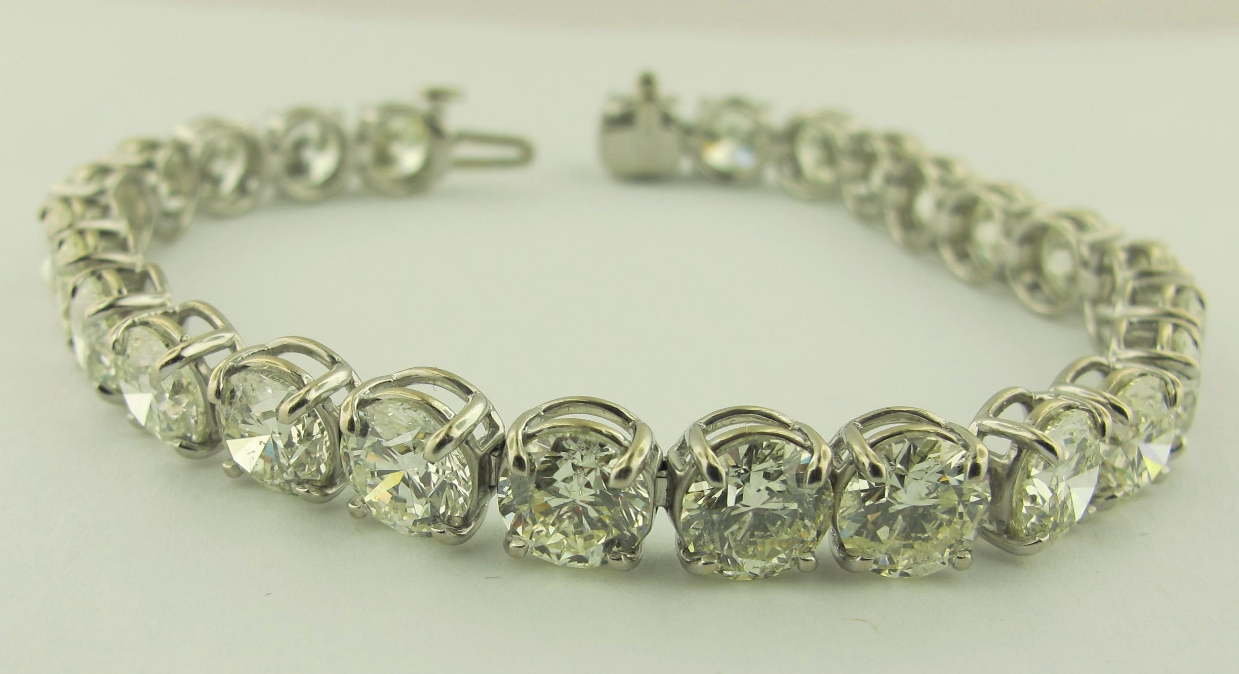 Straight-line Diamond bracelet with 26 round brilliant cut diamonds with a total weight of 19.24 carats.  Color J-K, Clarity VS.  Set in Platinum.