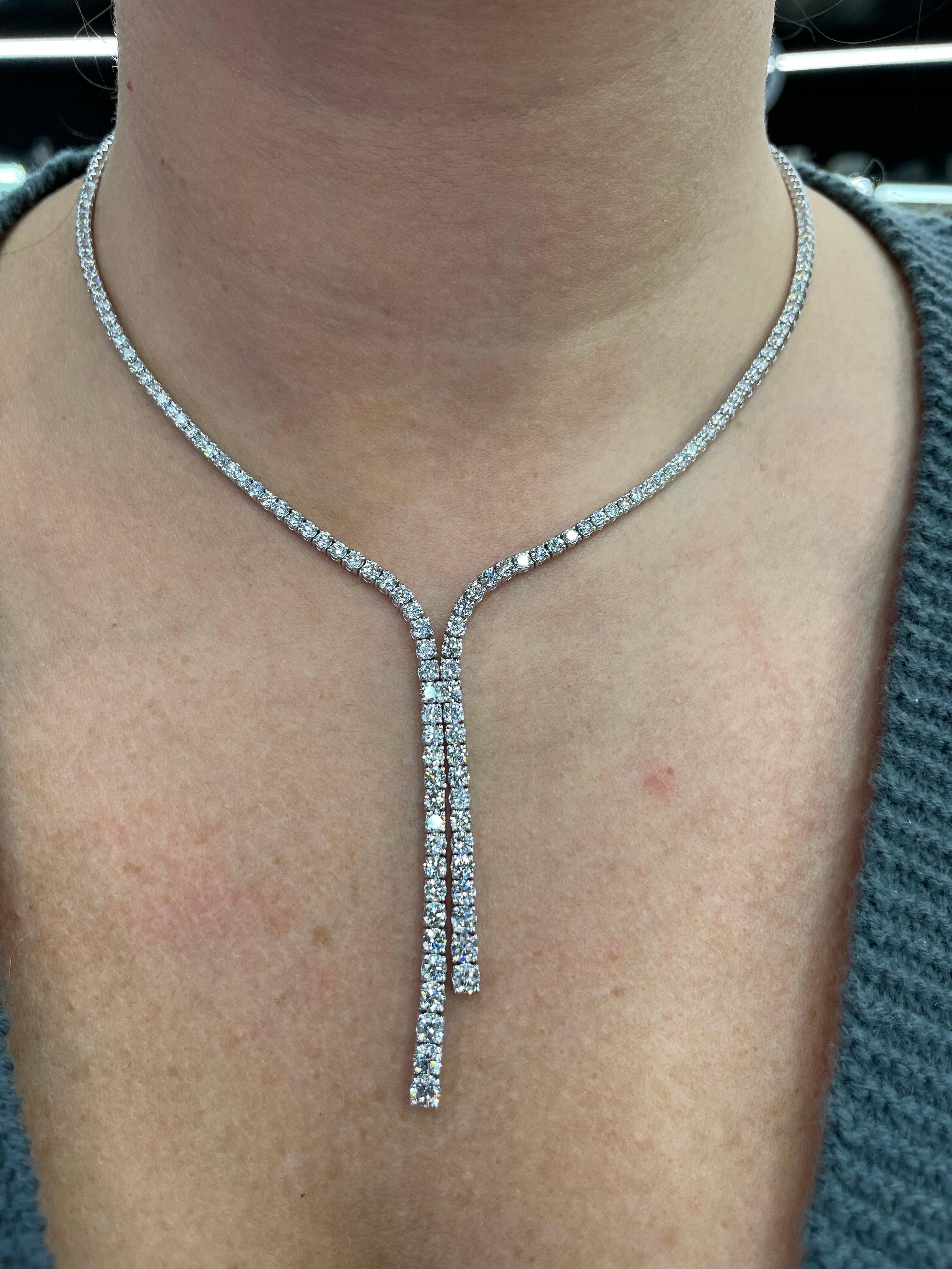 14 Karat White Gold tennis necklace featuring 118 round brilliants weighing 7.52 carats.
Color G-H
Clarity SI1-SI2

Drop measures 1.5-2 Inches long
Diamond illusion is 4 inches on each side. 