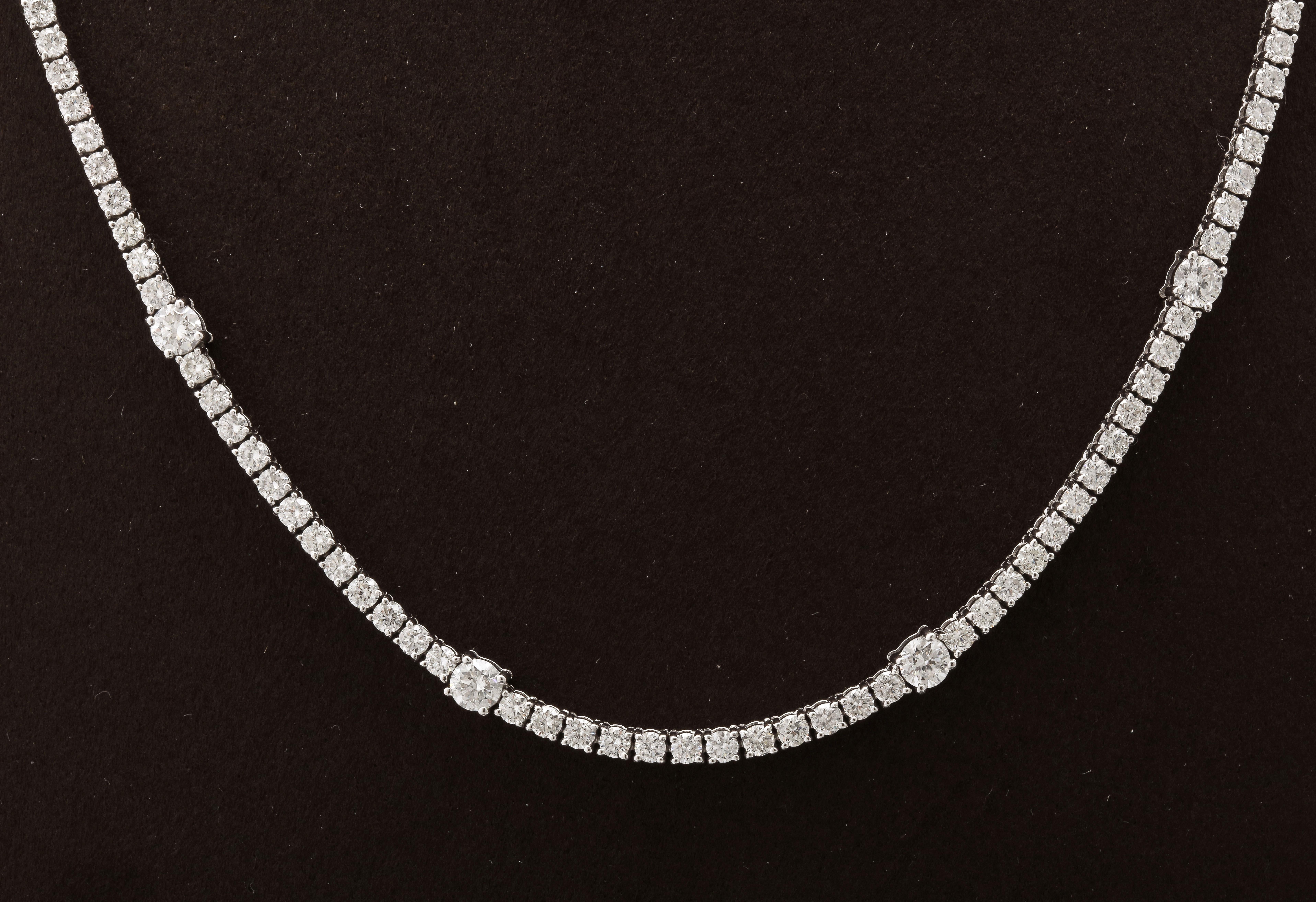 
A unique tennis necklace with 8 larger diamonds set throughout. 

8.15 carats of white round brilliant cut diamonds set in 18k white gold. 

16.5 inch length that can be adjusted if necessary. 

Looks beautiful on its own or layered with other