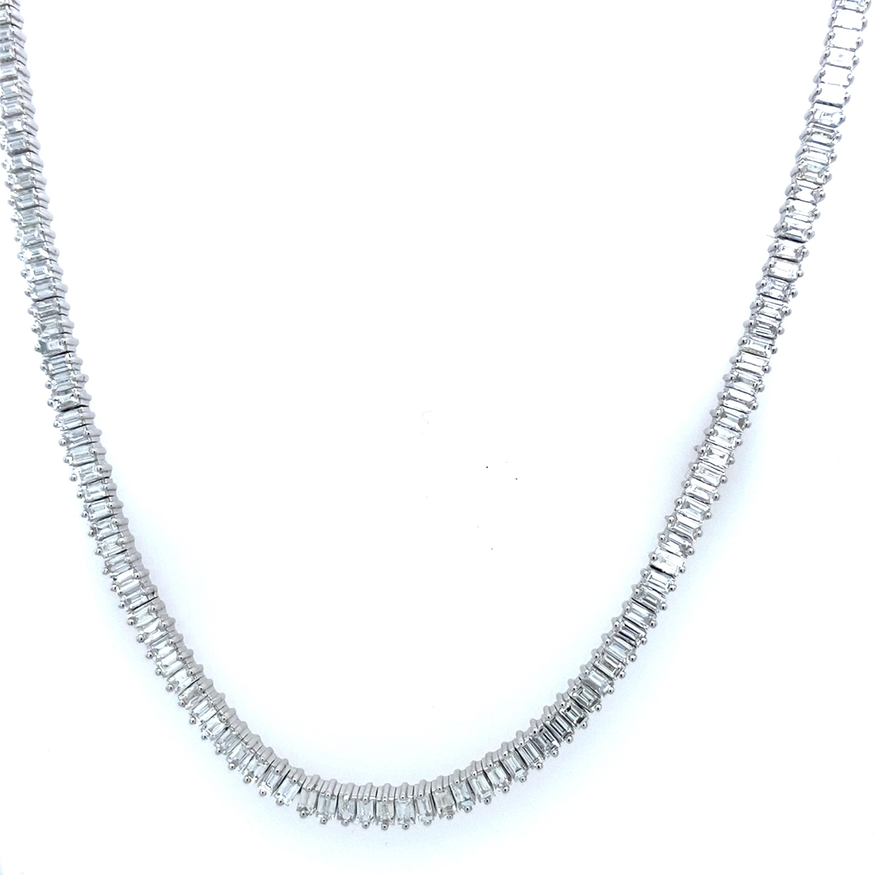 It is crafted in 18 carat white gold. This tennis necklace is set with 4.40 carats of baguette diamonds. It is a timeless piece that will never go out of style.

Additional Information: 
Total Diamond Weight: 4.40ct
Diamond Colour: G
Diamond