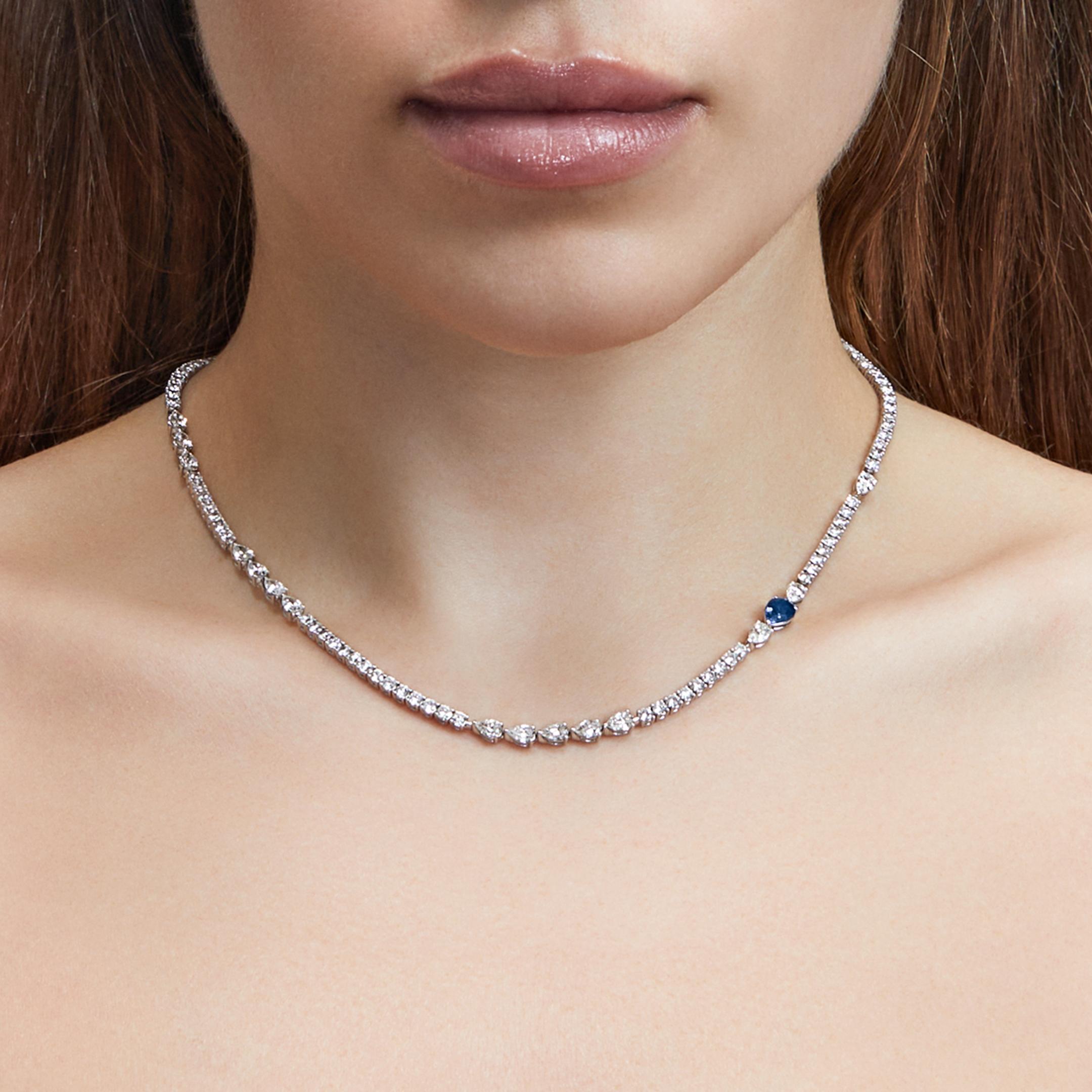 Meet the Blue Sapphire Diamond Tennis Necklace—a refined take on a jewelry staple. Alternating pear-shaped and round brilliant diamonds create a dynamic silhouette, while a singular pear-cut blue sapphire adds a touch of contrast. A modern