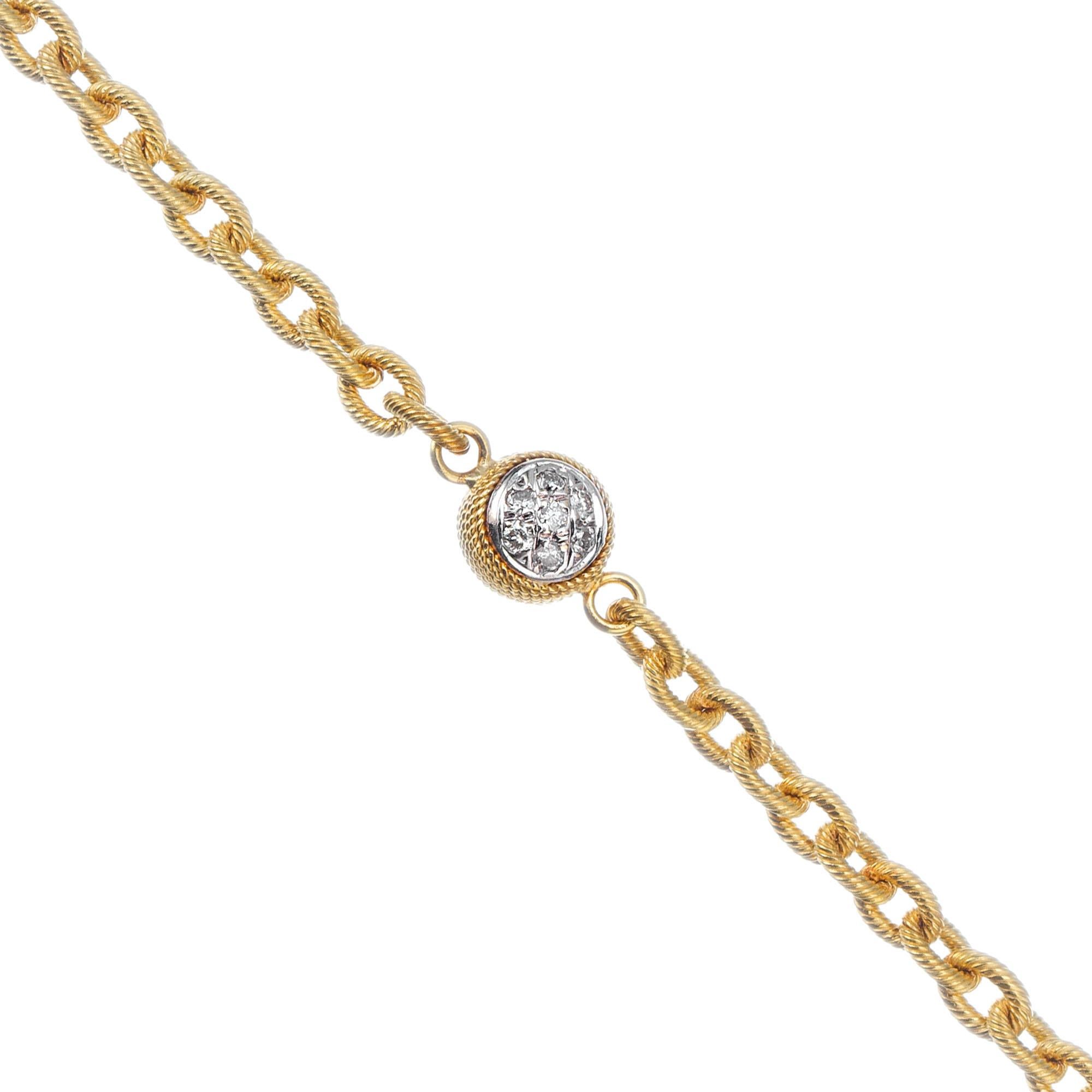 Two sided 18k yellow gold textured bracelet with 14 diamond ball cluster center. 7.25 inches. 

14 round full cut diamonds, approx. total weight .07cts, H, SI
18k Yellow Gold
Stamped: 750 18k
8.3 grams
Cable link chain: 3.60mm
Length: 7.25
