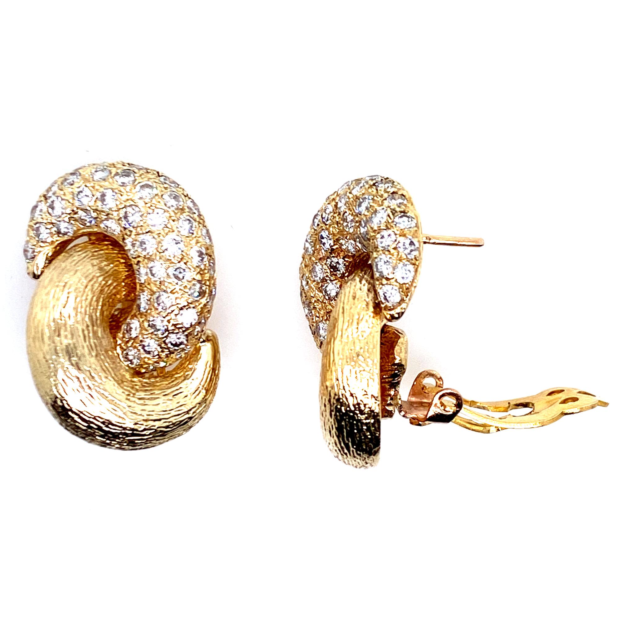 Gorgeous 1960's diamond knot earrings hand crafted in 14 karat yellow gold. The top knots feature 104 round brilliant cut white diamonds (5.00 CTW), graded F-G color and VS clarity. The earrings measure 20 x 30mm. 