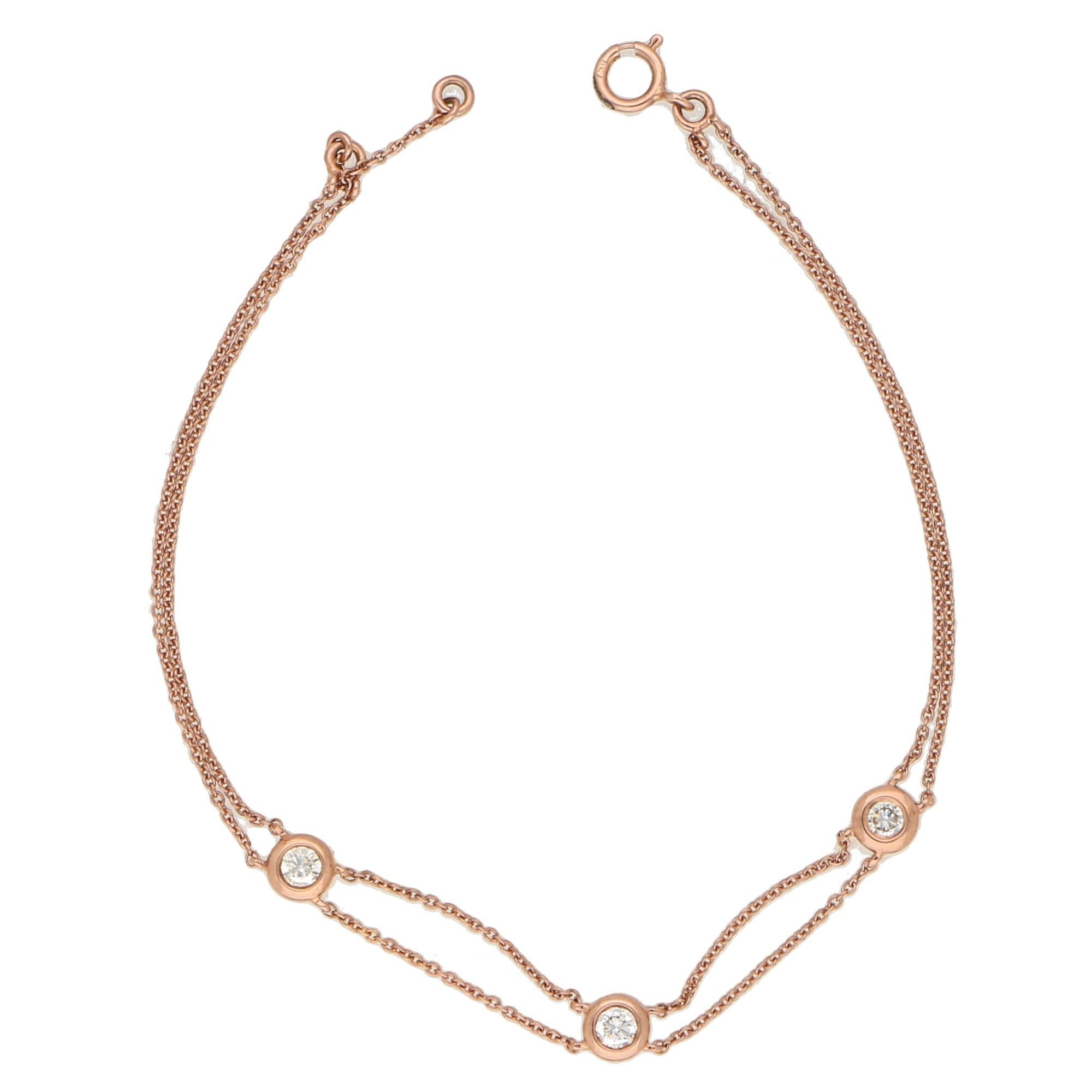 Total diamond weight: 0.27 carats, H/I colour, VS1/VS2 clarity.
A pretty diamond bracelet in 18K rose gold, set with three round brilliant cut diamonds in open back rubover settings, to a stylish double string design. 
This bracelet is fine,