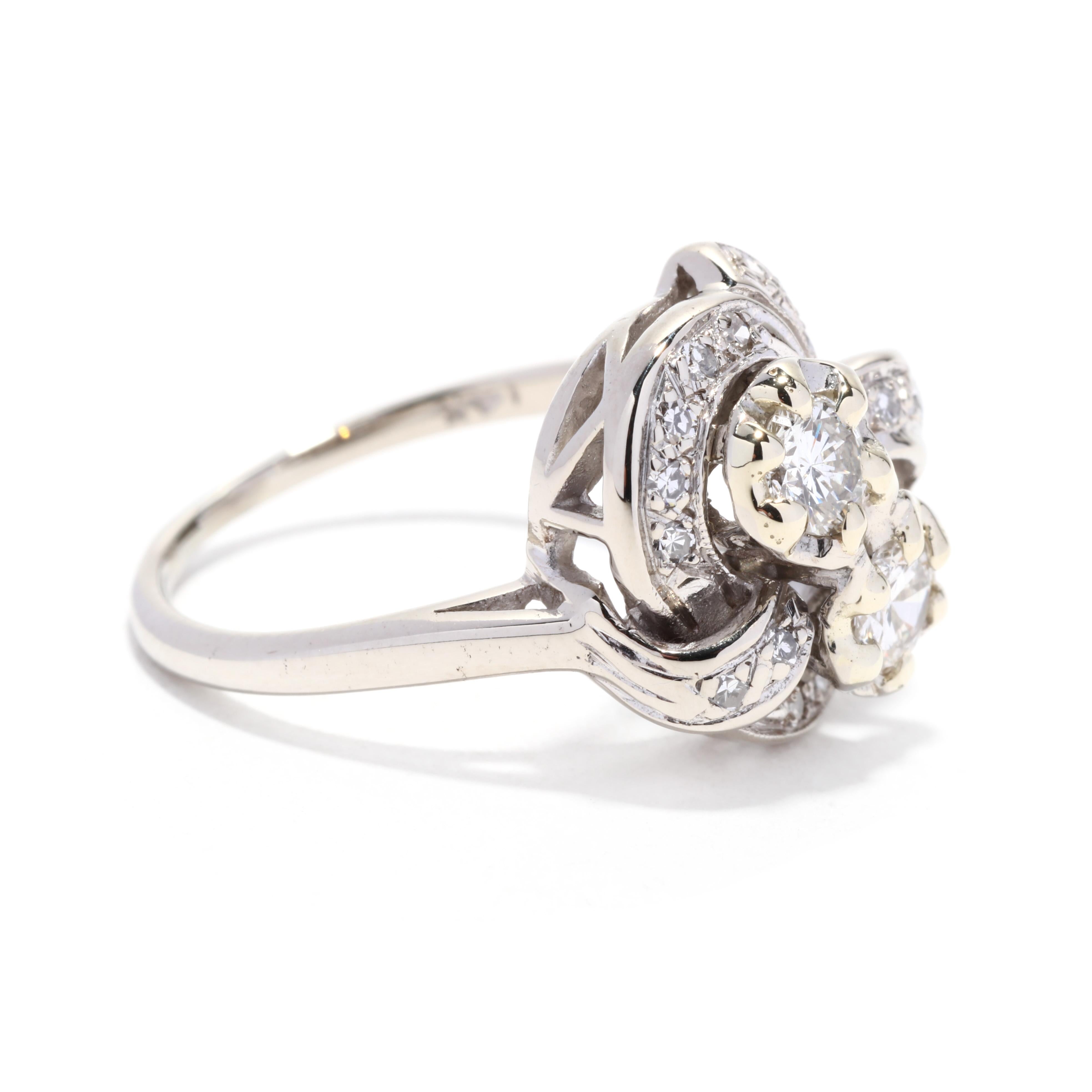 A retro 14 karat white gold diamond toi et moi ring. This classic diamond ring features a retro take on the toi et moi design featuring two central round brilliant cut diamonds weighing approximately .50 total carats and with a stylized bow motif