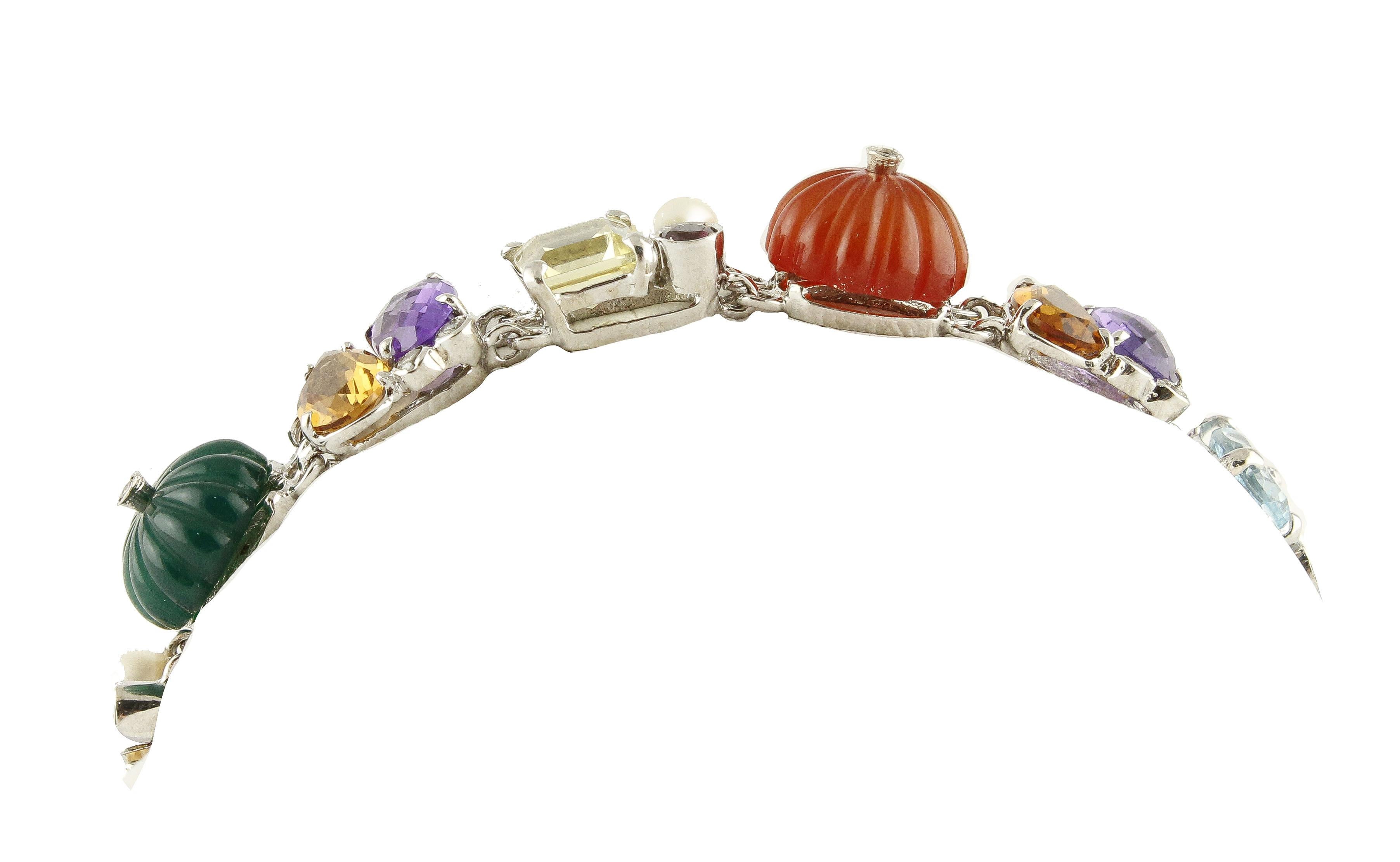 Unique rich link bracelet in 14K white gold structure, composed of 24.94 ct large variety of stones like tourmalines, square shape citrine, oval amethysts, drop shape yellow topaz, oval shape blue topaz, and 4.50 g of chalcedony carnelian green