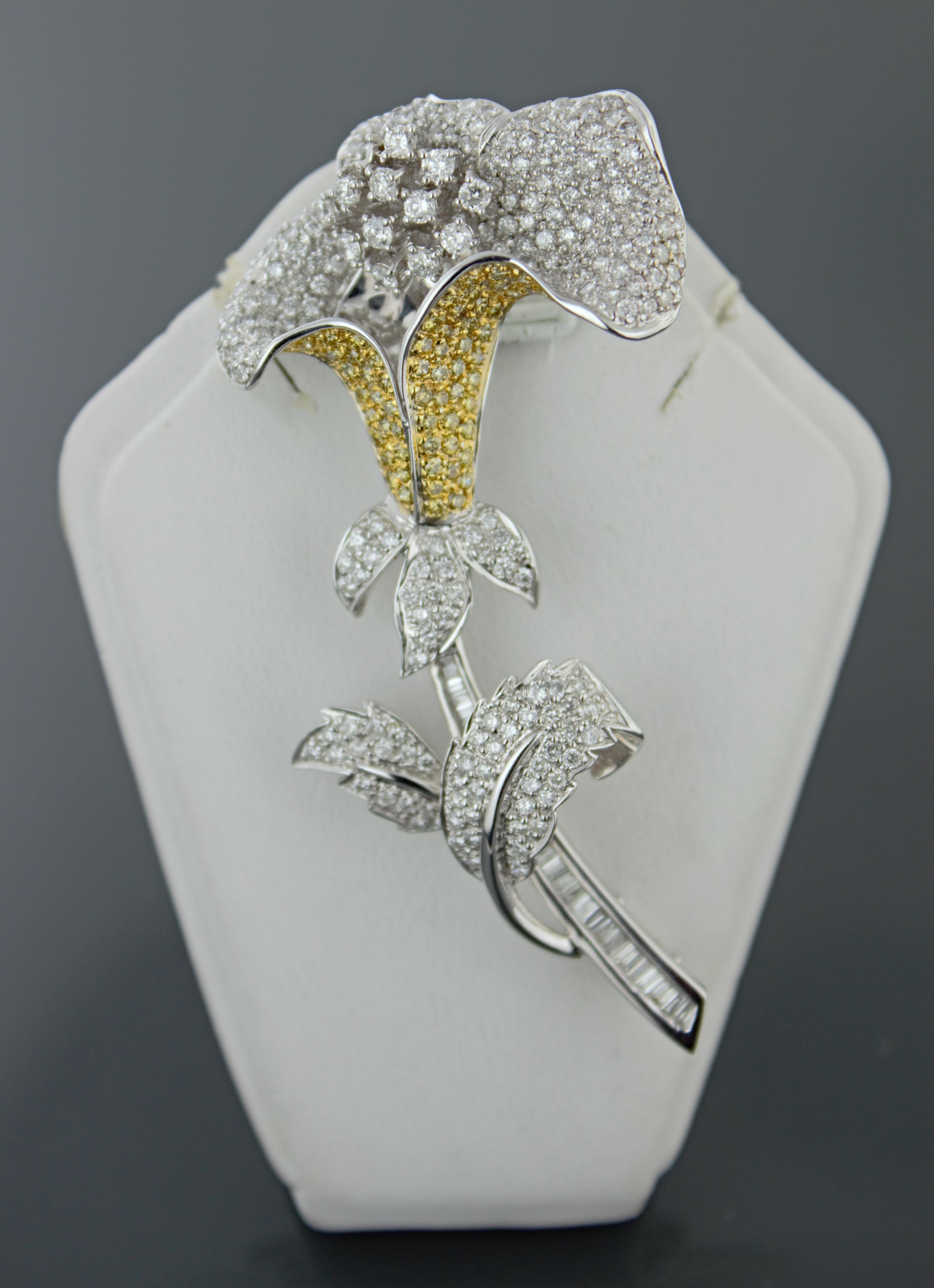 Featuring 239 full-cut, (30) baguette-cut, and 60 treated yellow full-cut diamonds, total diamond
weight is 5.35 carat total weight, I, I-J and yellow, pave and channel set in an 18k white gold sculpted flower
mounting, 65mm x 32.2mm x 13mm, marked