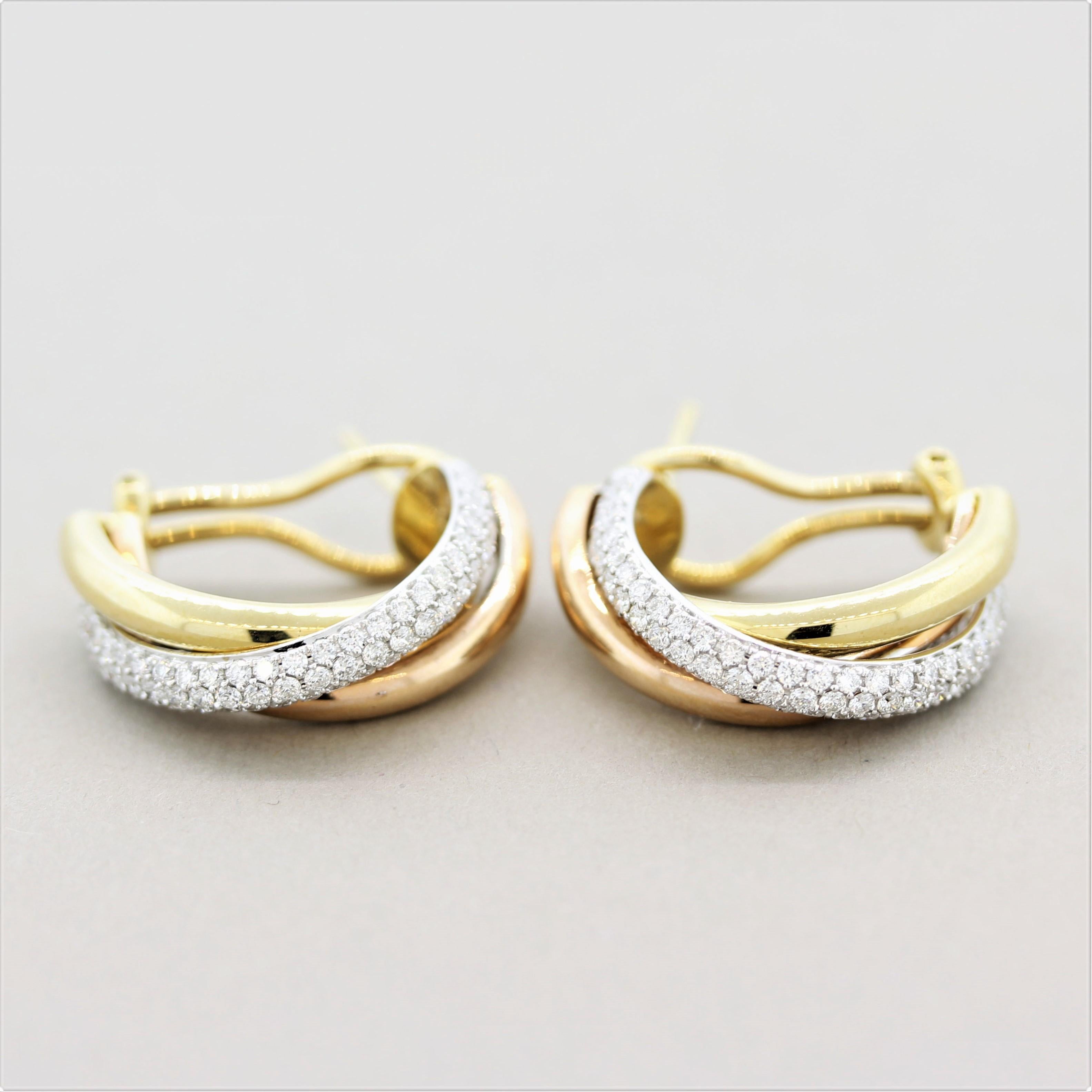 A sleek and sexy pair of earrings featuring 1.27 carats of round brilliant-cut diamonds. They are set over 18k white gold while two other hoops twist around it, one in yellow gold while the other rose gold giving the piece a unique tri-tone style.