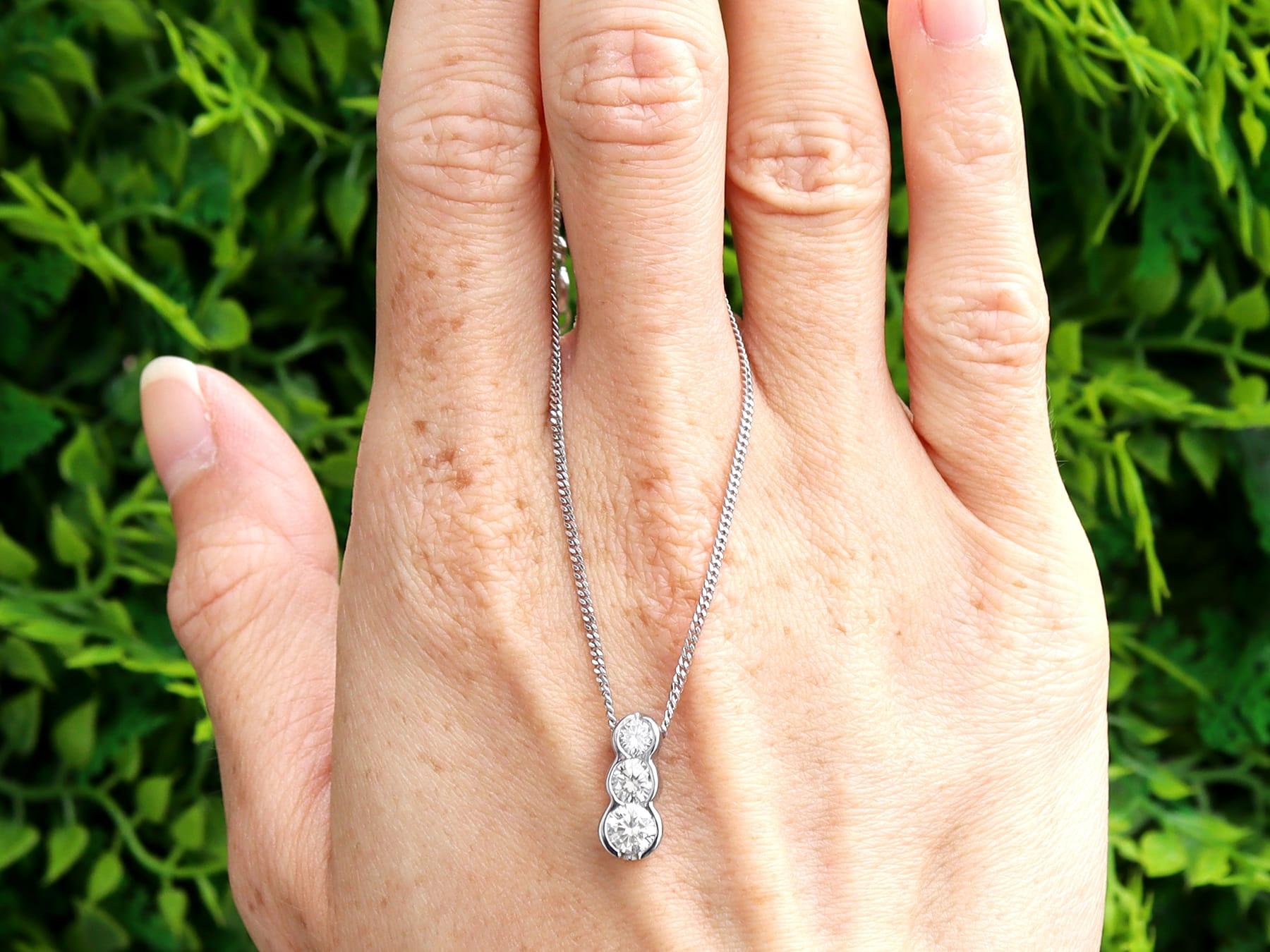 A fine 0.58 carat diamond and platinum trilogy/ three stone pendant; part of our diverse contemporary jewelry and estate jewelry collections.

This fine contemporary three stone pendant has been crafted in platinum.

The pendant features three