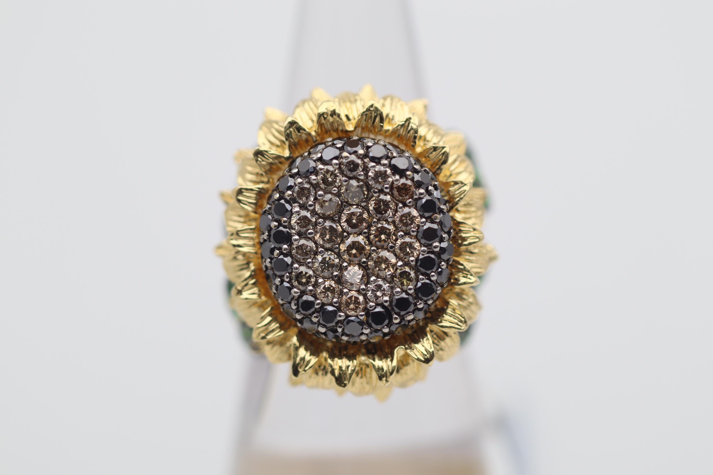 A beautifully sweet cocktail ring masterfully crafted into a sunflower! It features 2.22 carats of fancy brown and black diamonds set in the center of the sunflower with a convex indentation for a realistic look. Adding to that, 0.82 carats of