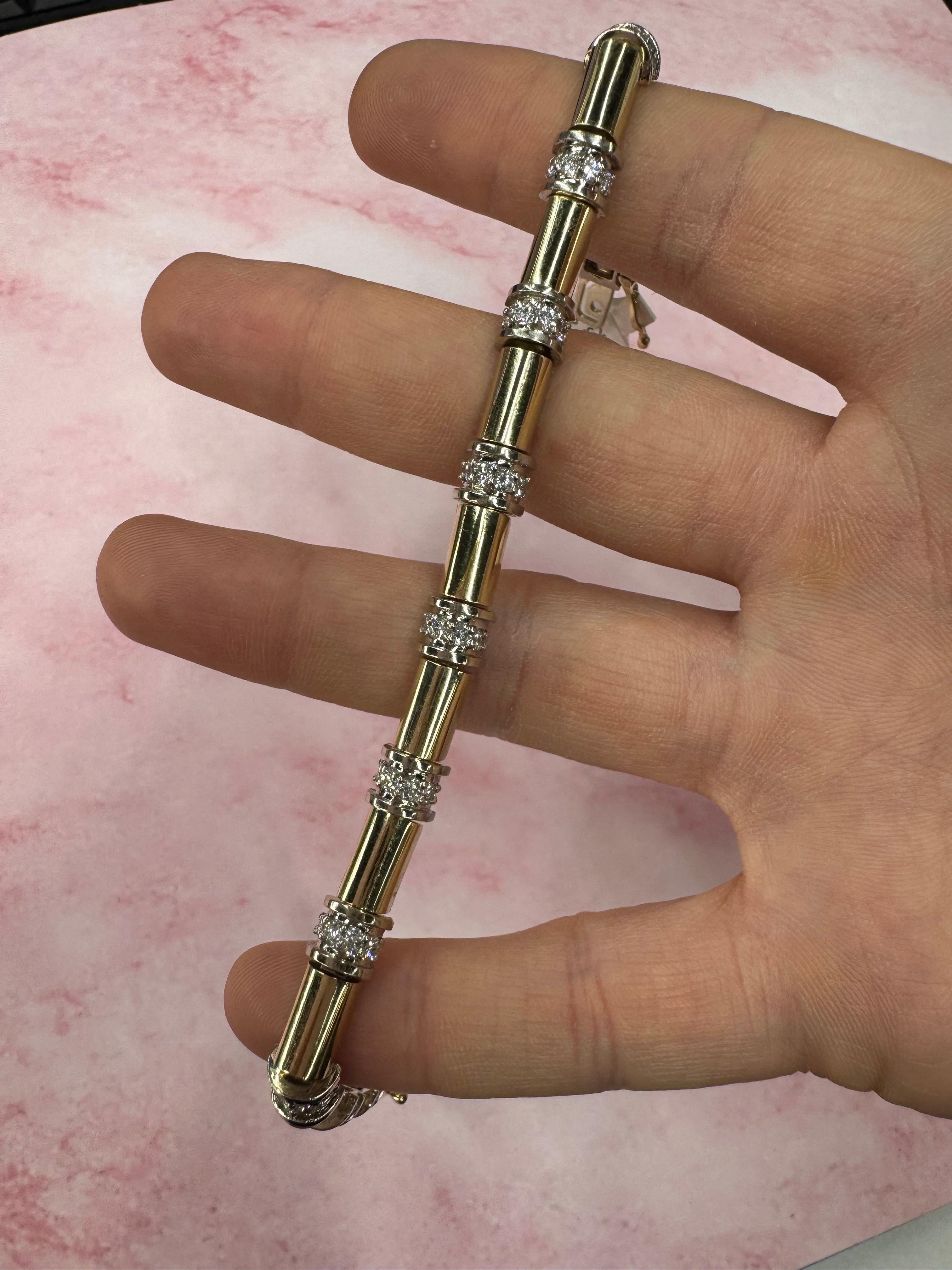 18 Karat yellow link bracelet featuring diamond bars in between with a total of 44 round brilliants weighing 1.85 carats. 
 
Measurements:
Width: 0.25