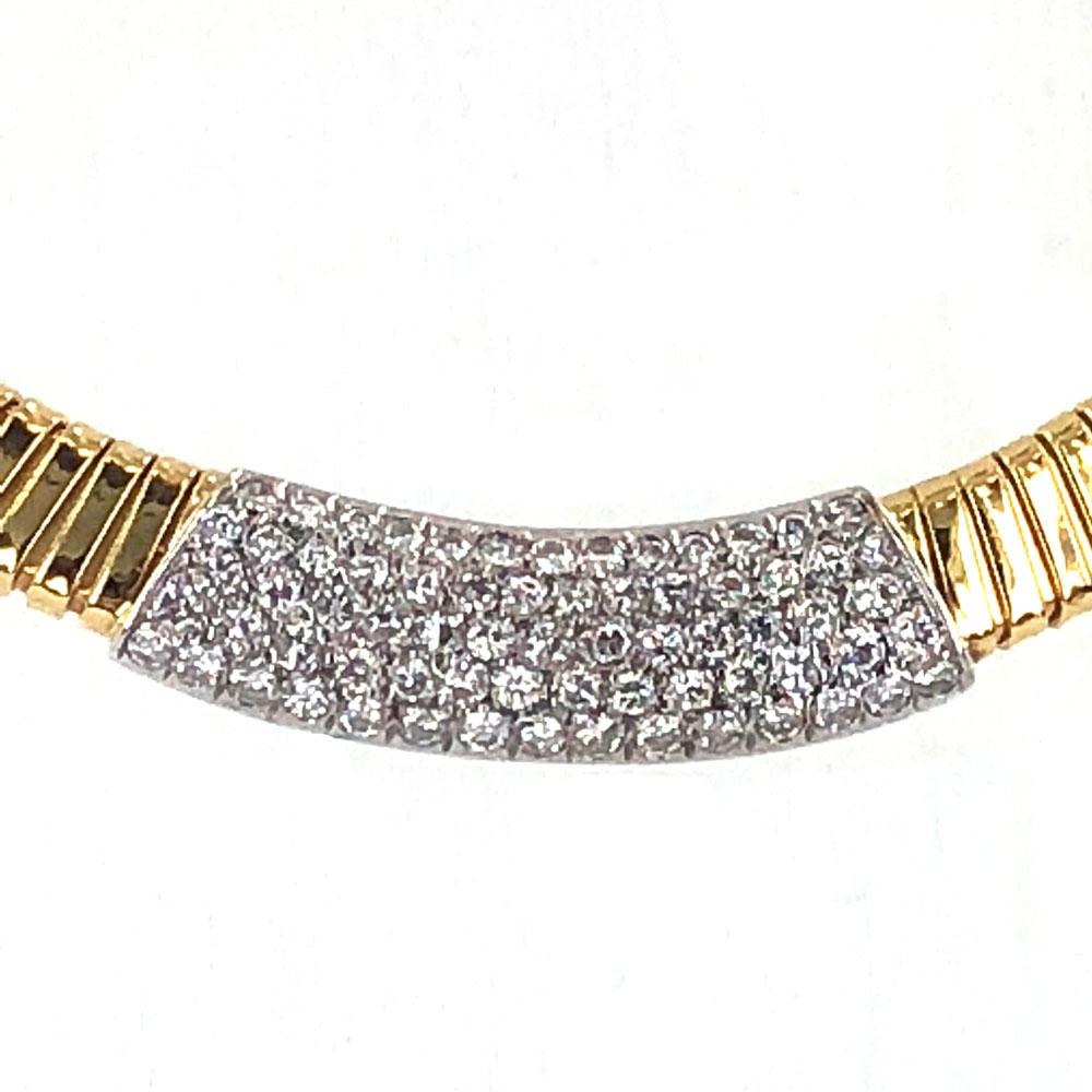 This timeless diamond choker necklace is fashioned in 18 karat two tone gold. The yellow gold tubogas flexible link features a white gold diamond section in front. The 3.50 carats of round brilliant cut diamonds are set in 18 karat white gold and