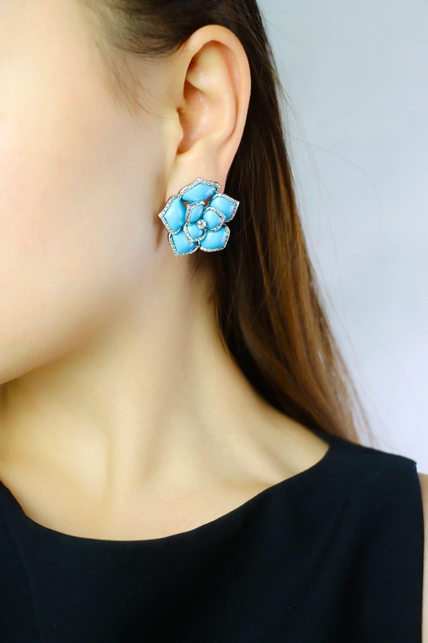 Diamond Turquoise 18K White Gold Flower Earrings
Opaque robin's egg blue in color with bead set diamond edges.
I-L color with VS2 clarity - with additional diamond in centers.
Completed by hinged omega backs with optional
