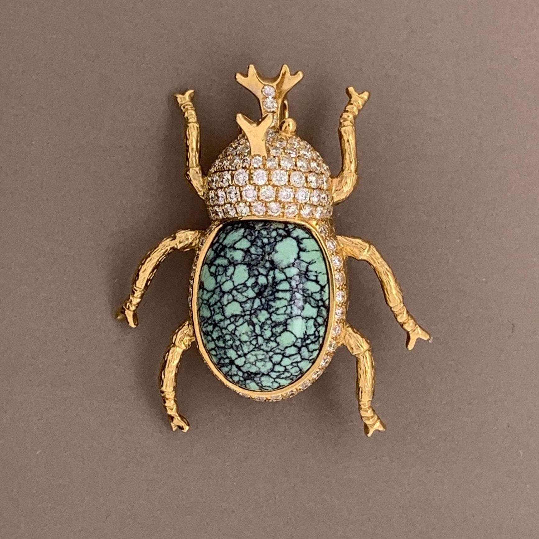 Beware of this beetle and its horn! This ferocious critter features 1.00 carat of round brilliant cut diamonds set around its body and horn. A fine piece of spiderweb turquoise is used for its abdomen which adds contrast and realism to this piece.