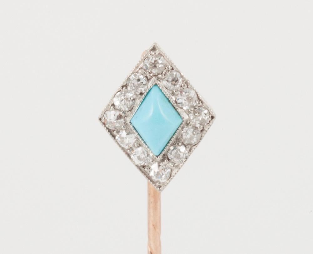 Late Victorian old cut brilliant diamond cluster tie or lapel pin, with lozenge cut turquoise centre set in platinum and mounted in 18 carat yellow gold.
Measures 10mm in height x 6mm in width.
Antique piece (over 100 years old).
Late 19th century,