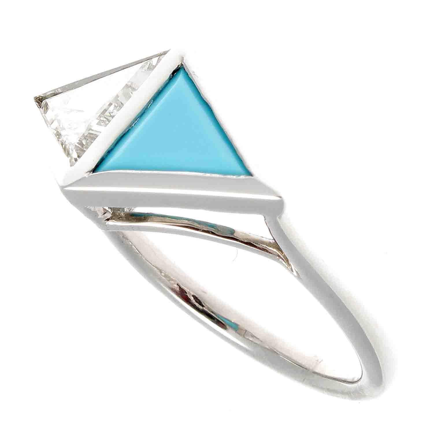 Creativity exposed through a symbiotic relationship of color and technical geometric design. Featuring a 0.97 carat triangular cut diamond that is K color, SI2 clarity that has been perfectly paired with an electrifying turquoise stone. Hand crafted