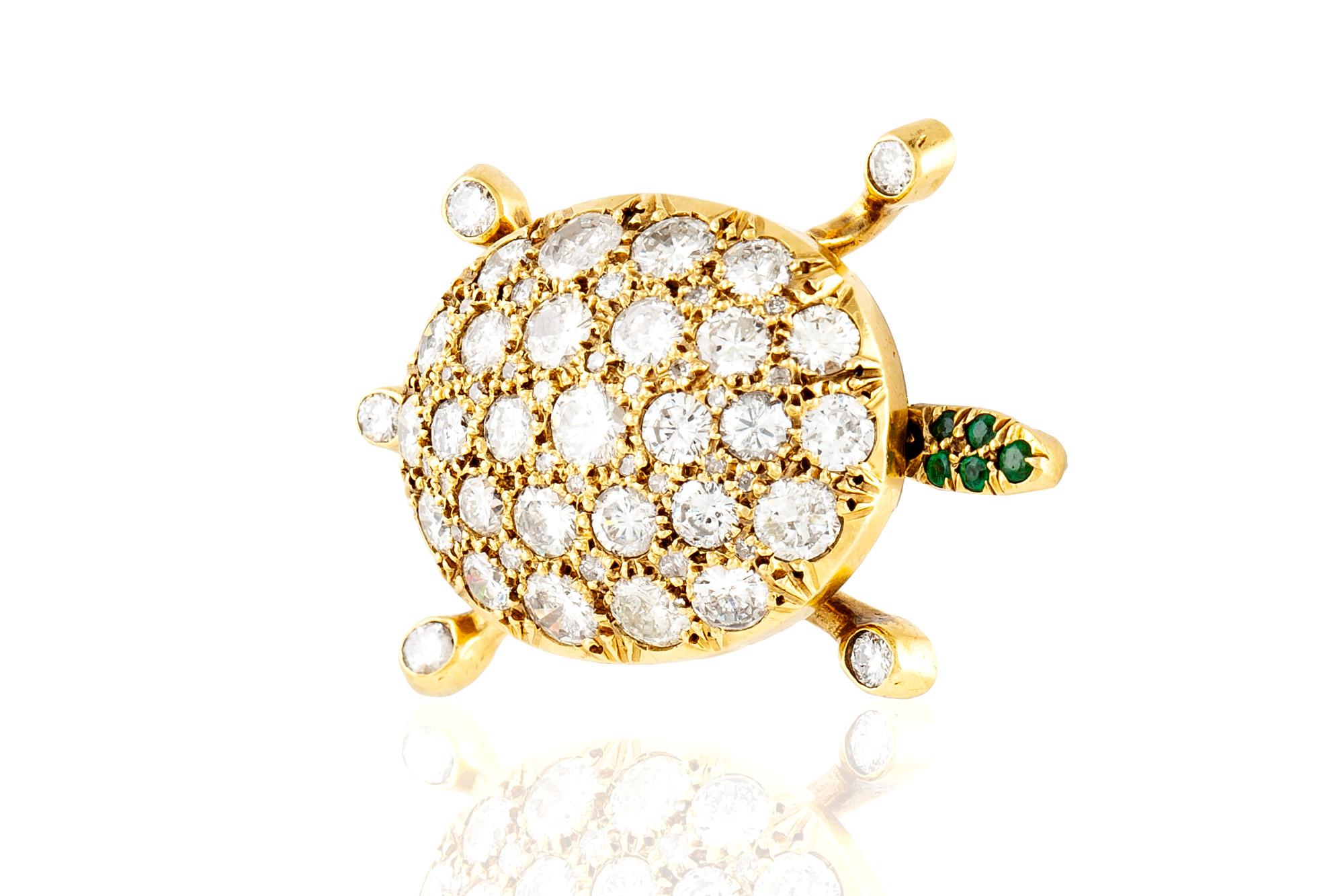 Turtle brooch. finely crafted in 18 k yellow gold, with brilliant cut diamonds, weighing a total of approximately 9.00 carat and round cut emeralds on the head.