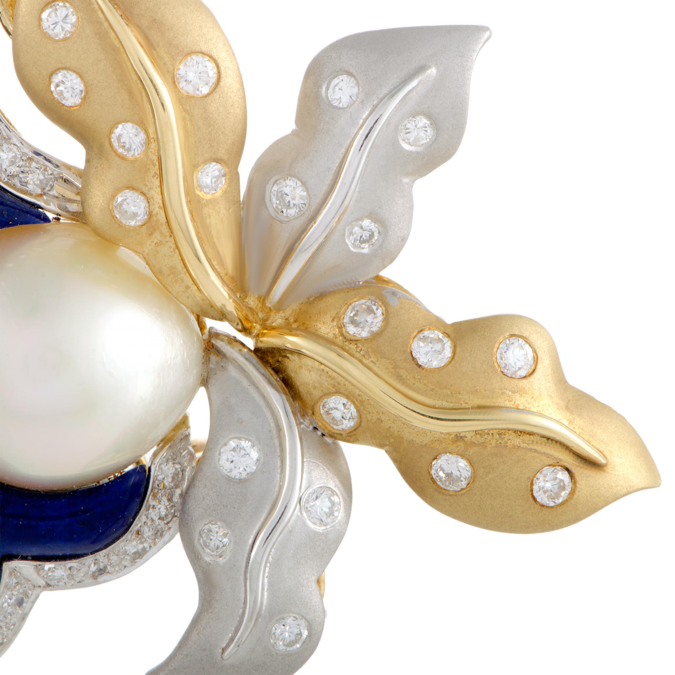 A majestic composition of gracefully smooth shapes, delightfully joyous colors, and charming luxurious radiance, this fabulous brooch is made of 18K yellow and white gold and embellished with a gorgeous twin pearl, splendid lapis lazuli, and