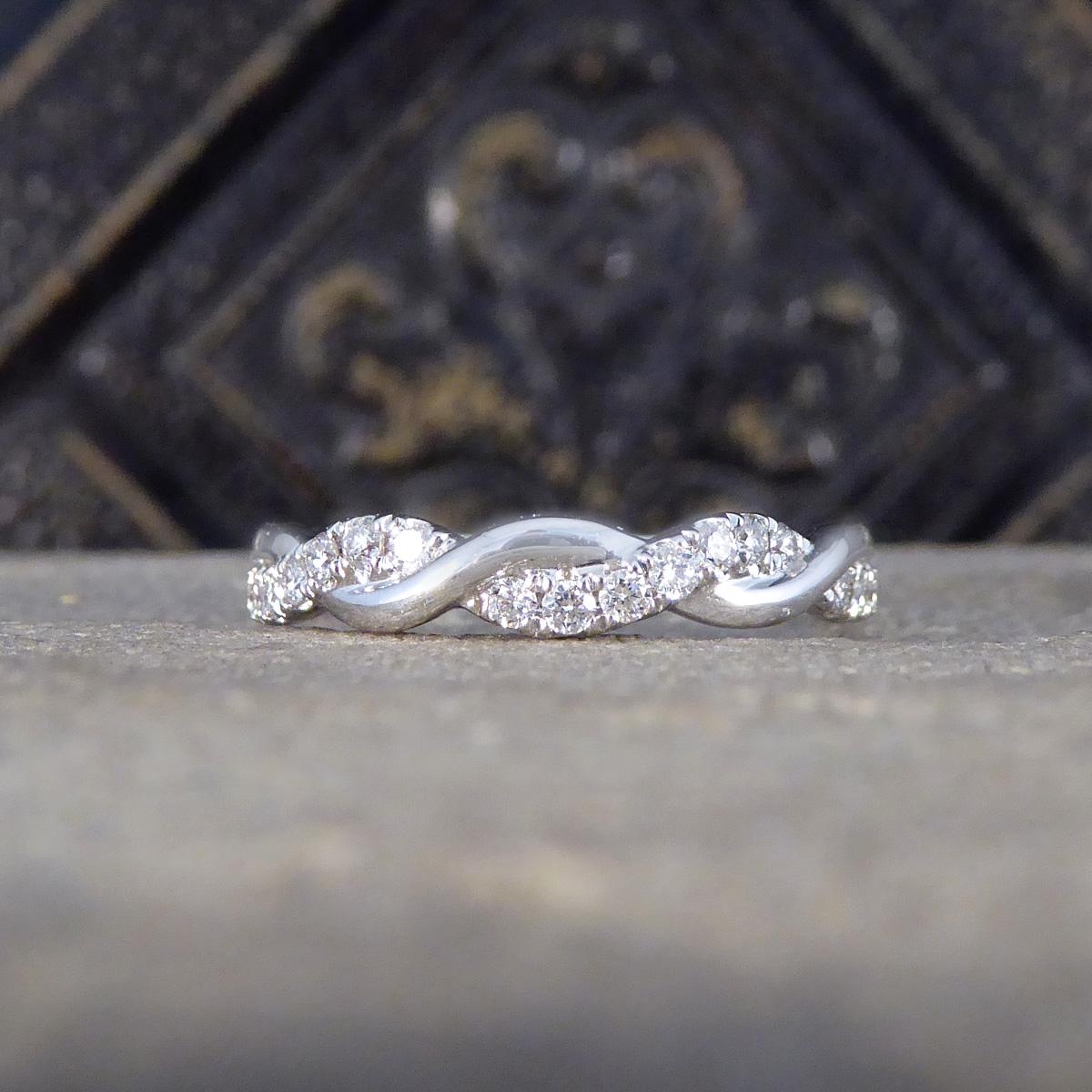 A gorgeous and symbolic Diamond Twist Band Ring in 18ct White Gold, a harmonious blend of sophistication and style. This lovely ring features a captivating design and crafted with precision with the plain polished thread intertwining seamlessly with
