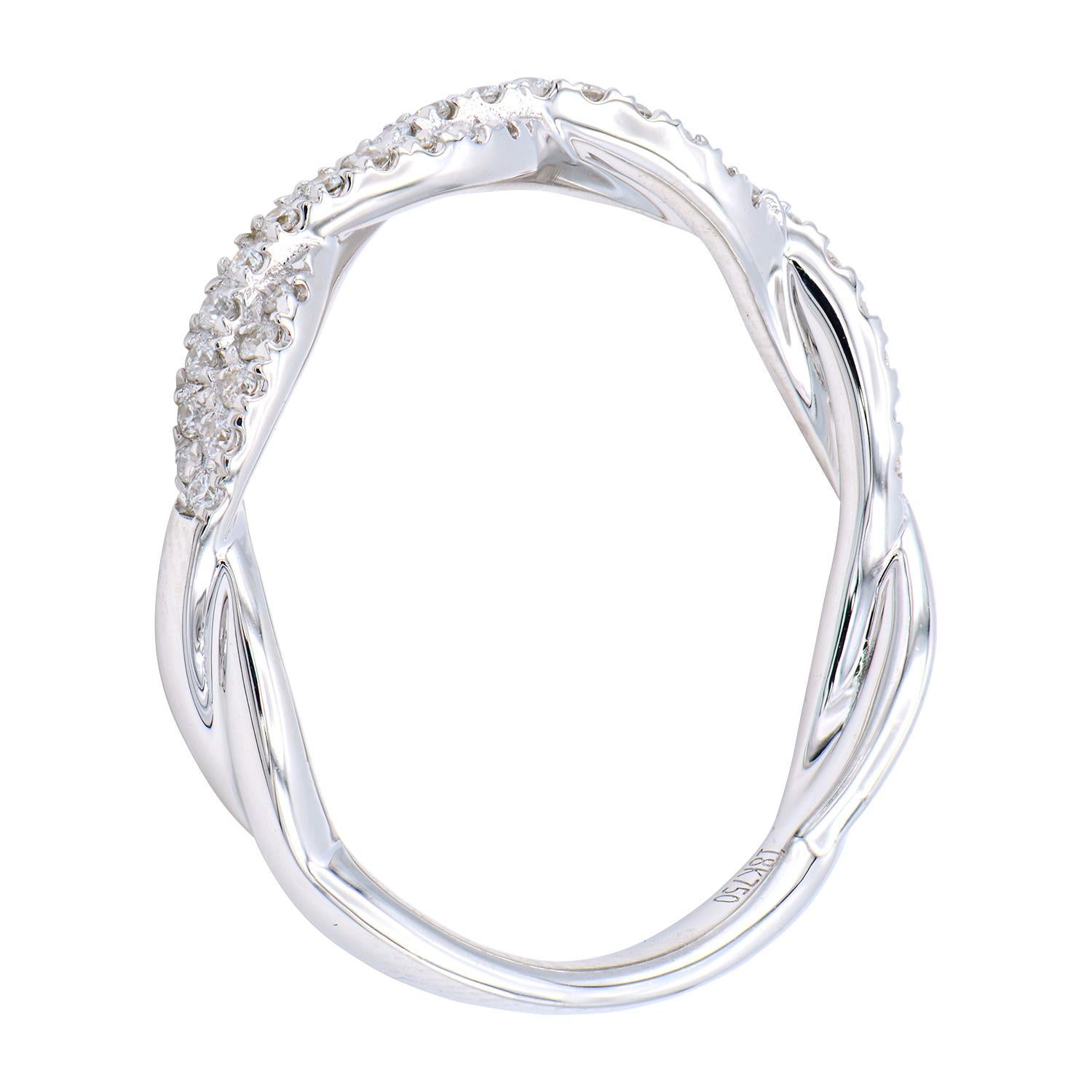This beautiful diamond band looks like a twist which is made of 43 round VS2, G color diamonds totaling 0.20 carats. These shining diamonds are set in 2.4 grams of 18 karat white gold. This ring is size 6.5 