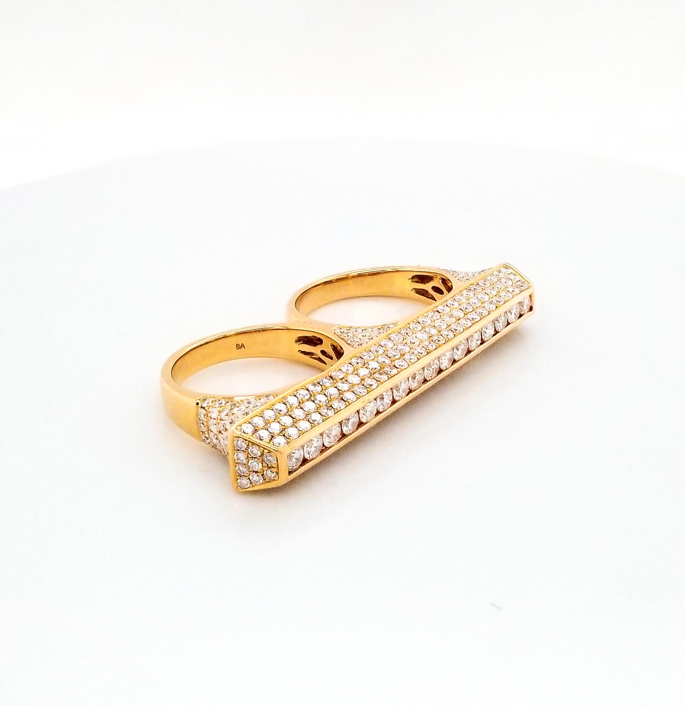 Stylish modern ring that goes on two fingers. 
It is embellished with pave diamonds weighing 3.10 carats and mounted in 18K rose gold.
The weight of gold is 14.26 grams.
The diamonds are equivalent to G-I colors, VS-SI clarity.
Size of the ring is