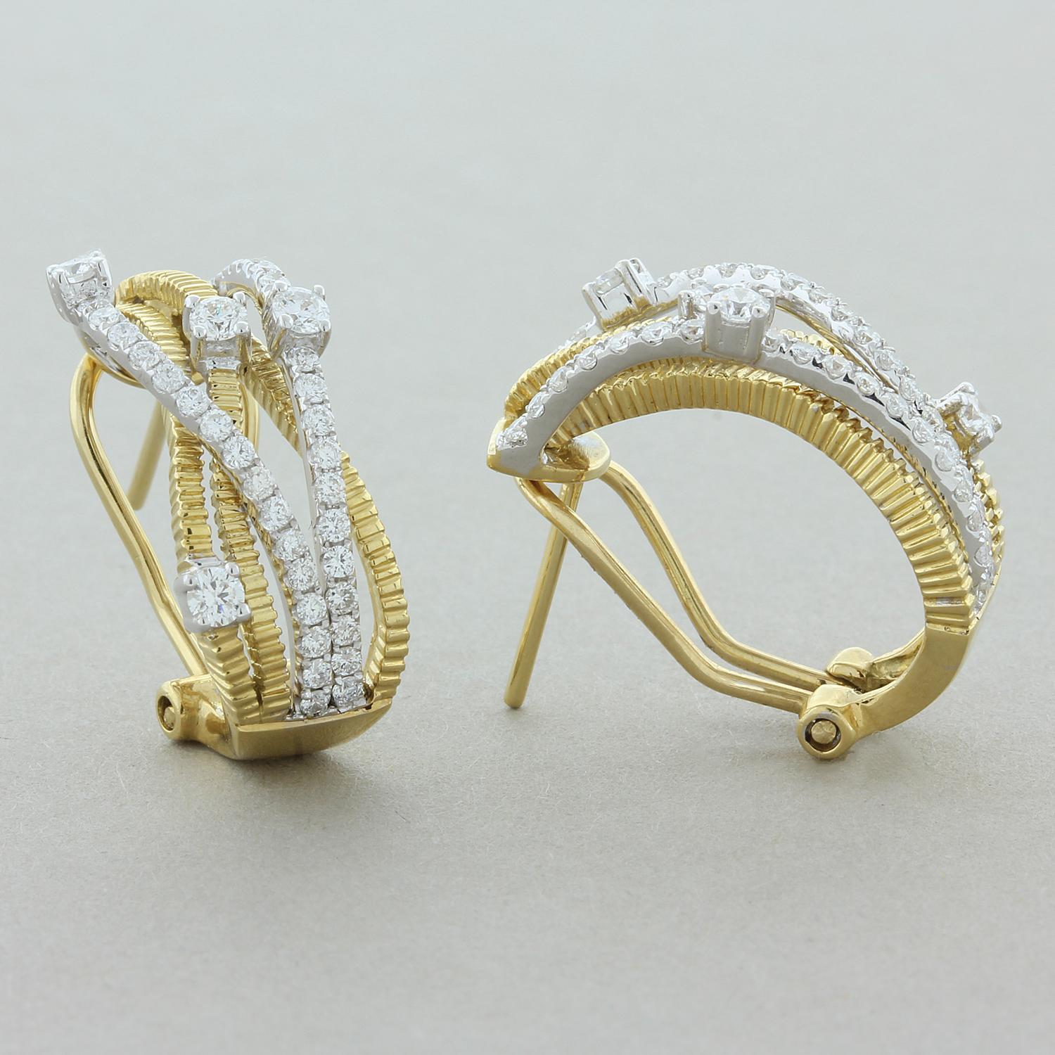 A fabulous pair of earrings featuring 0.98 carats of round brilliant cut diamonds. They are set in a curved two-tone 18K yellow and white gold setting adding to the look of these playful earrings. A great pair of earrings that can be worn day or