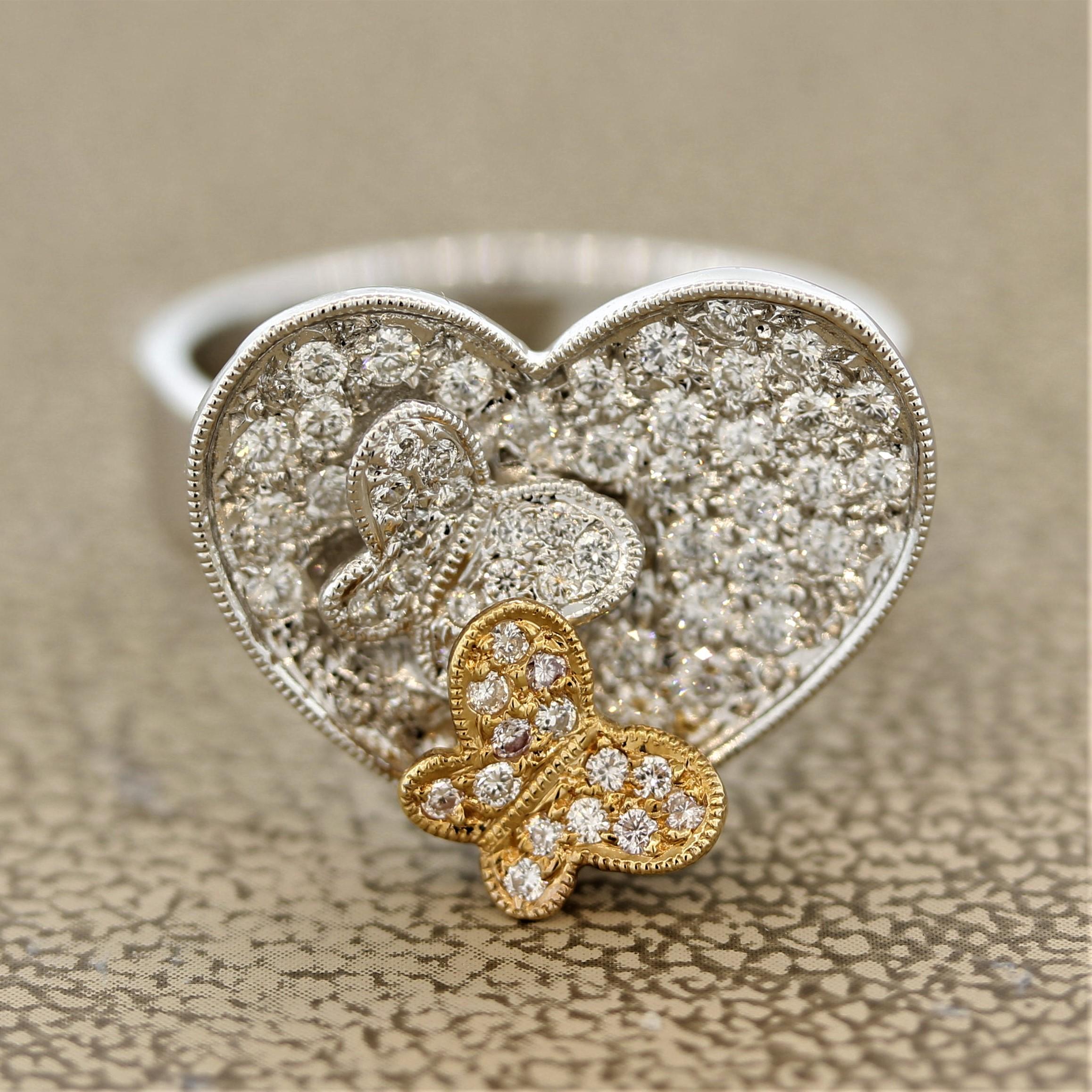 A sweet ring featuring 2 butterflies over a heart of love! They are set with 0.59 carats of round brilliant cut diamonds. One of the two butterflies is made in 18k rose gold while the other is made in 18k white gold along with the heart and rest of