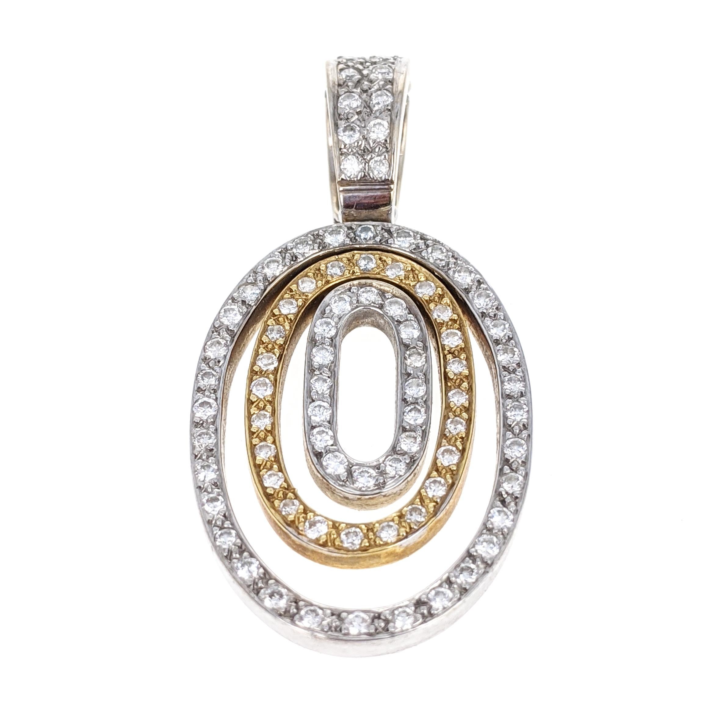 This pendant features three oval drops of alternating 18 karat white and yellow gold. It is pave-set throughout with round brilliant-cut diamonds weighing approximately .8 carat total. It is marked 18k and measures approximately 1.63 inches long by