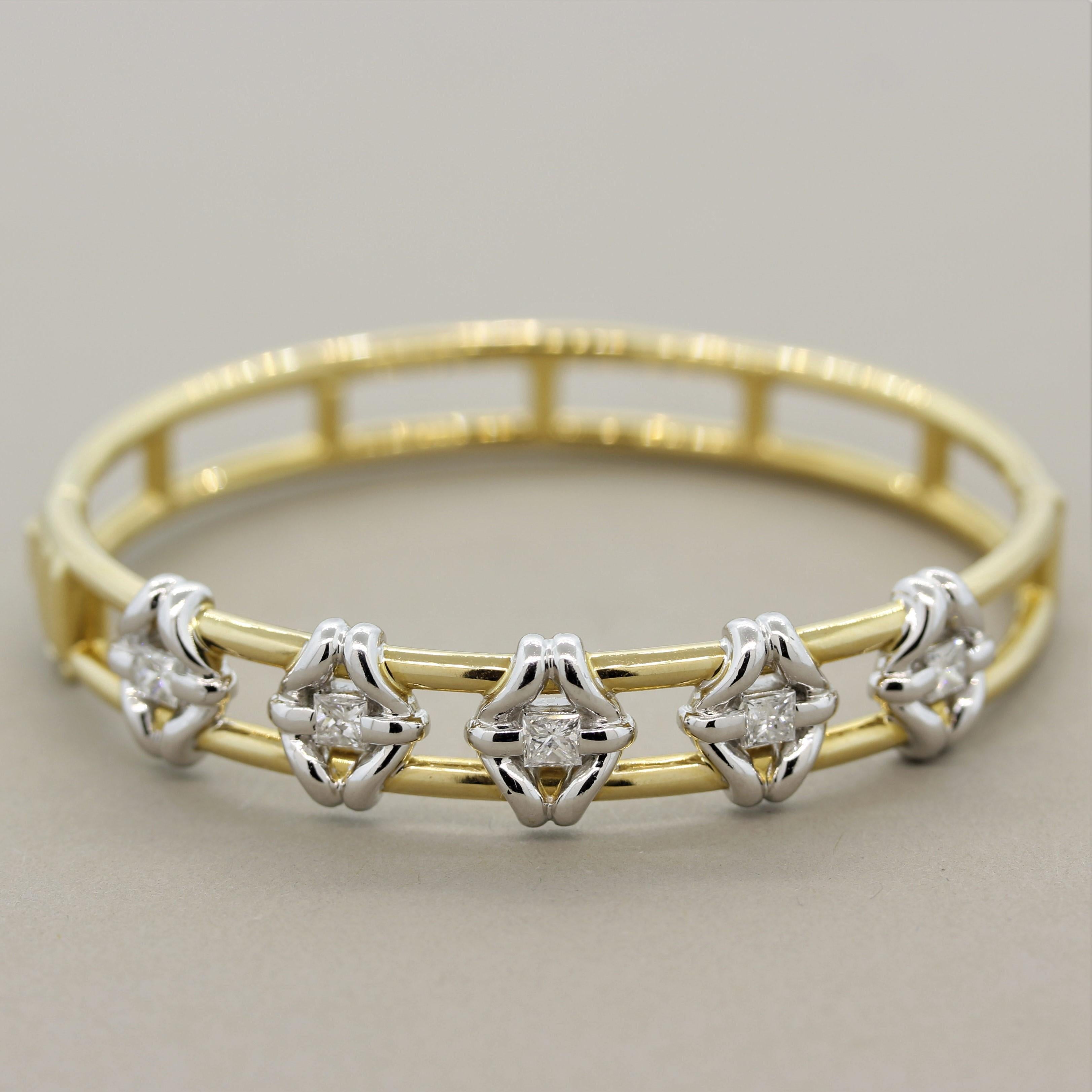 A uniquely styled bangle bracelet featuring 5 large princess cut diamonds weighing a total of 1.12 carats. They are set in platinum while the rest of the bracelet is made in yellow gold giving the piece a two-toned look. Made in 18k gold and