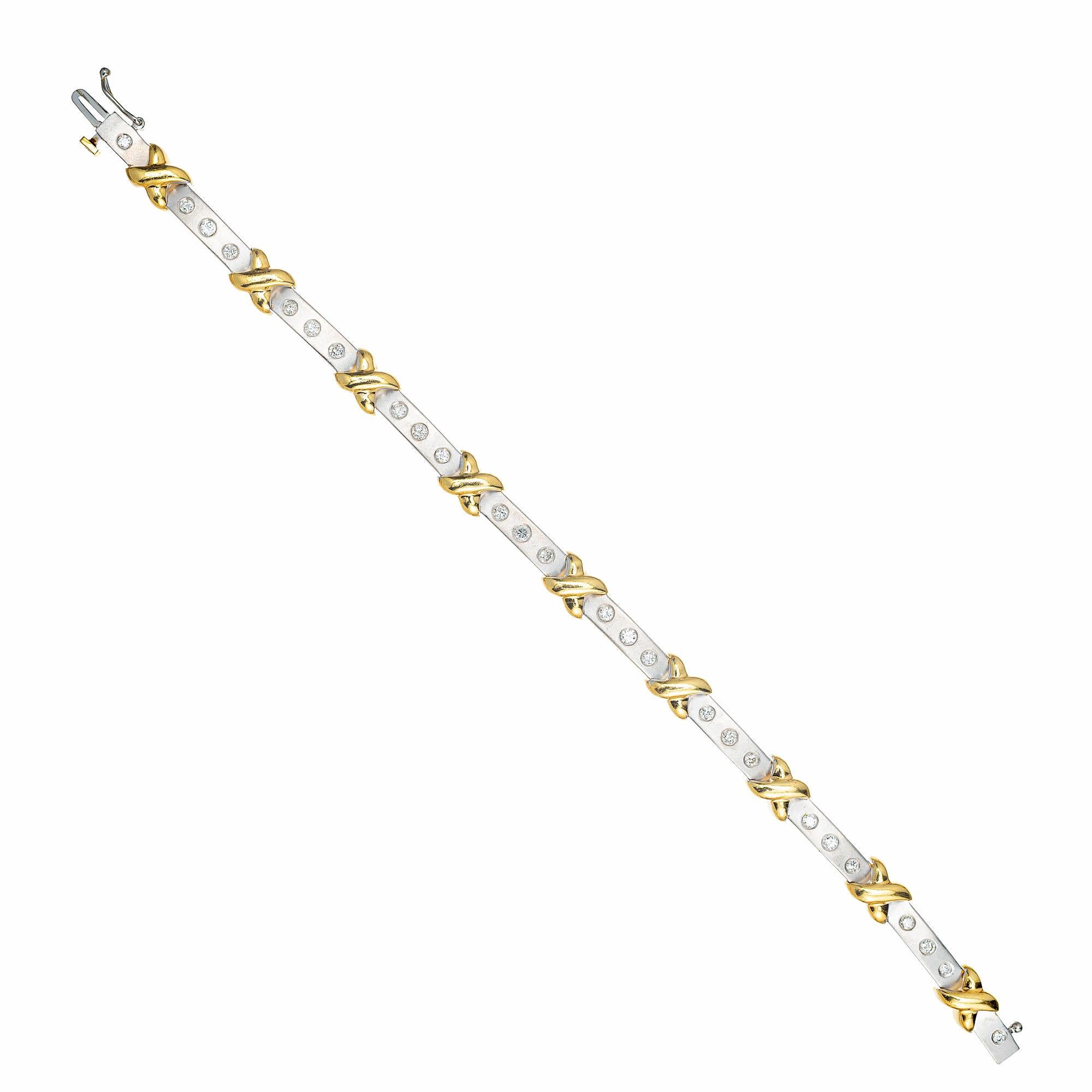 Diamond gold hinged link bracelet. 26 round diamonds in 18k white gold textured bar links with 18k yellow gold 