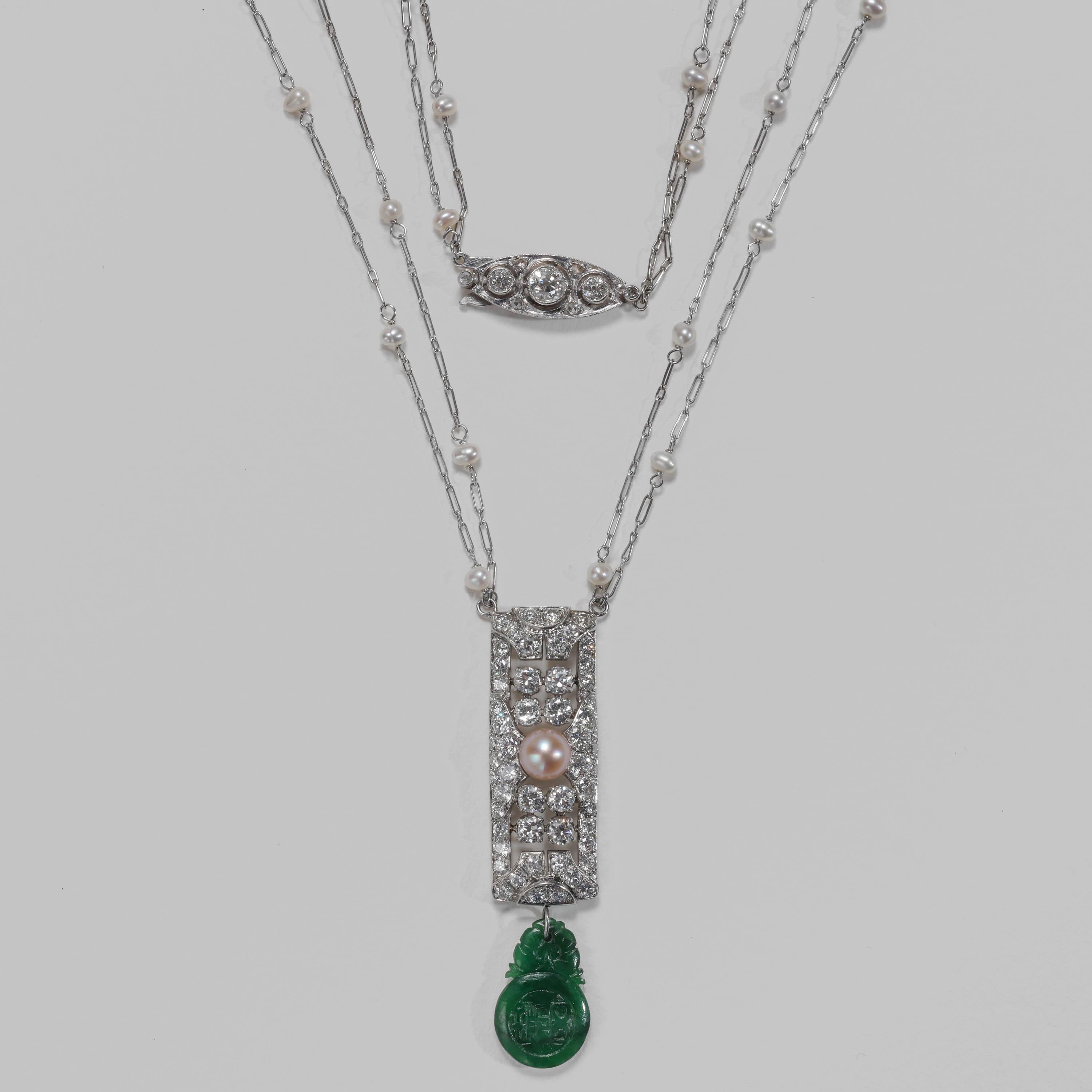 This Art Deco pendant necklace —ablaze in old diamonds— features two of the rarest and most precious gems on earth: natural pearl and natural, untreated jadeite jade. The sleek and permanently stylish platinum Art Deco jewel is composed of two